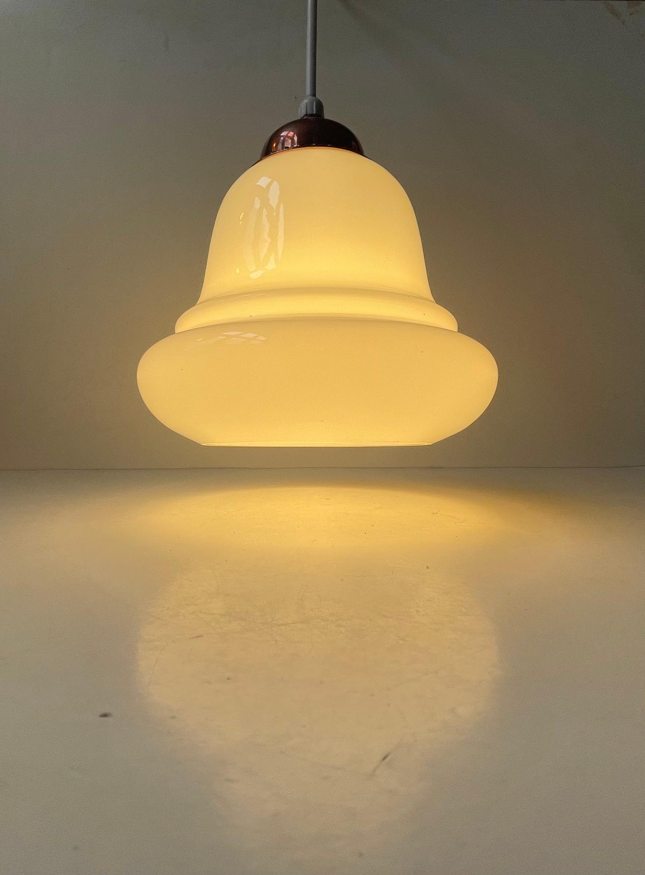 Un'elegante lampada a sospensione a forma di campana in spesso vetro opalino bianco. Realizzato da Holmegaard in Danimarca negli anni Quaranta. Si chiama Bell Type 2 ed è molto rara con la parte superiore in rame. 

Misure: H. 22 cm, Diametro 20 cm.