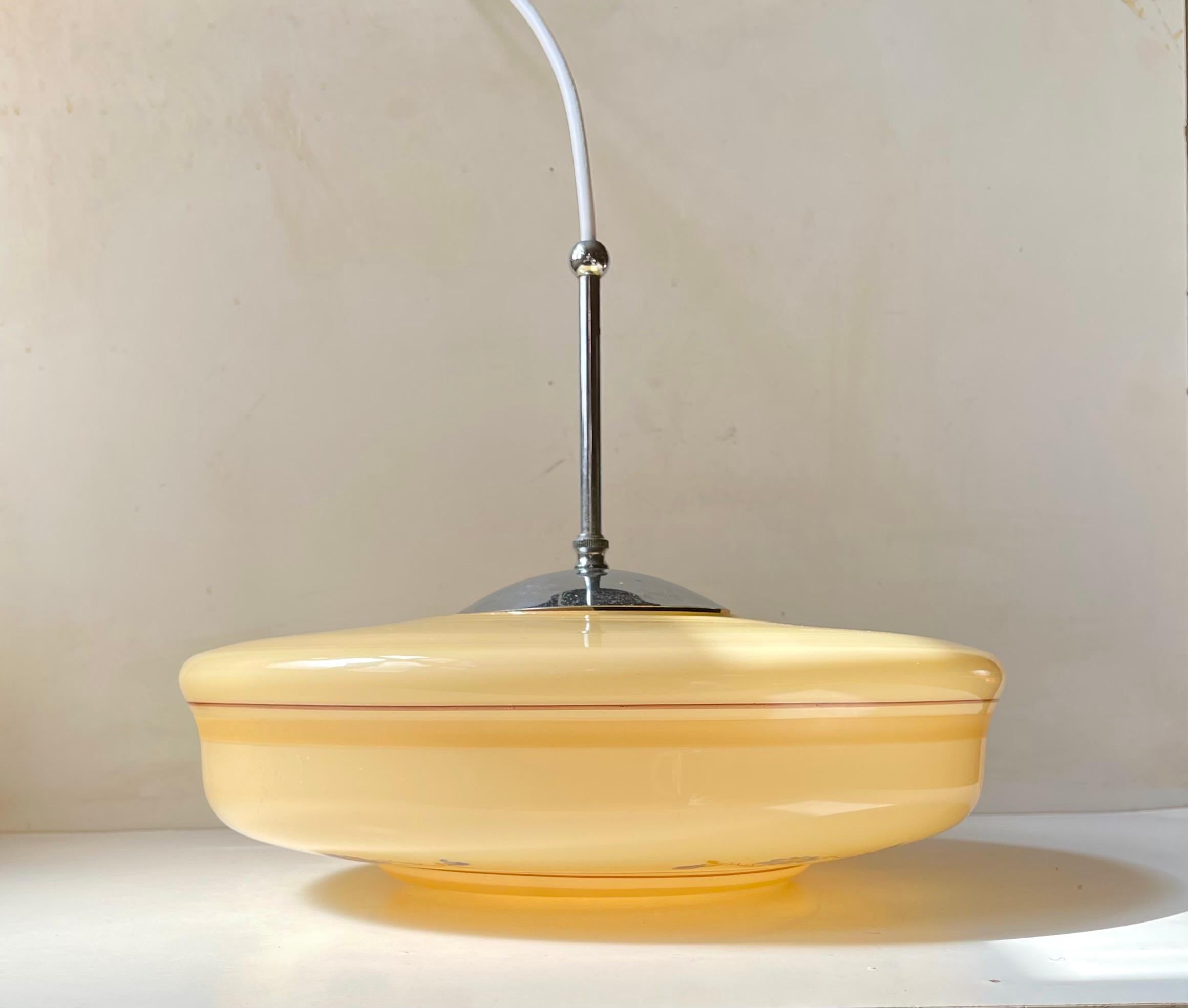 A large/wide saucer shaped ceiling lamp composed of yellow toned opaline glass and nickel plated top and original canopy. It was made in Denmark during the 1940s in a style reminiscent of Bauhaus and Art Deco lighting. Please notice it has 5
