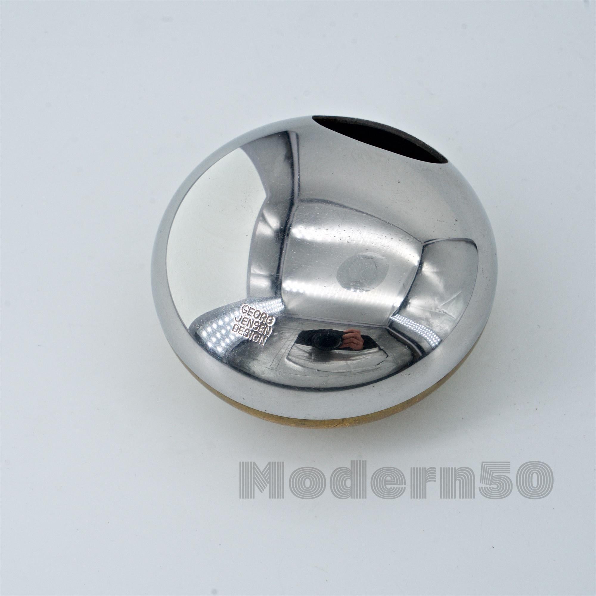 Polished two metal petite orb ashtray, marked Georg Jensen Design.