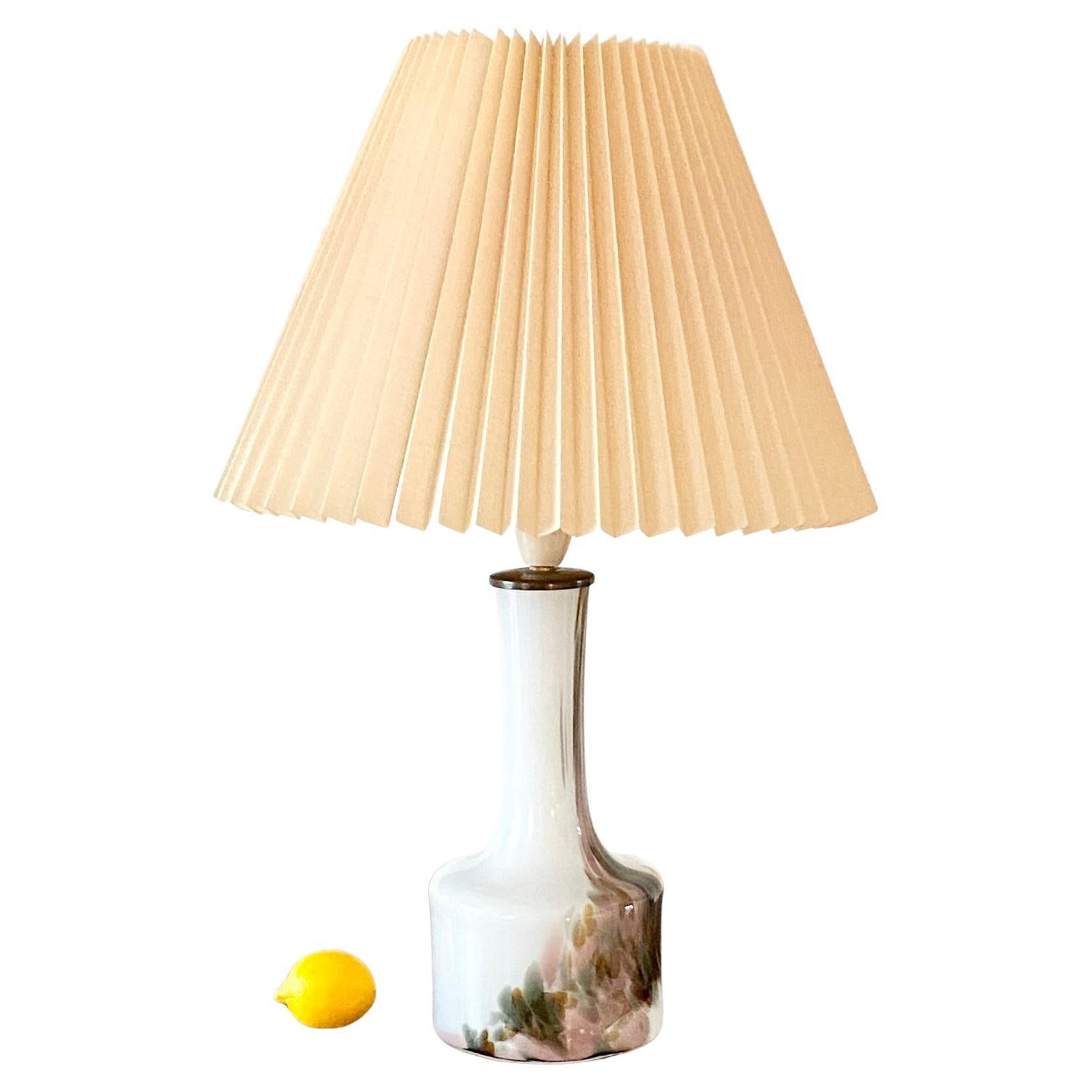 Rare handblown Art glass holmegaard table lamp by Per Lütken

Holmegaards Cascade table lamps was designed around 1970 by Per Lütken (1916-1998) and are considered very rare due to limited production.
They are made in opaline glass with colored