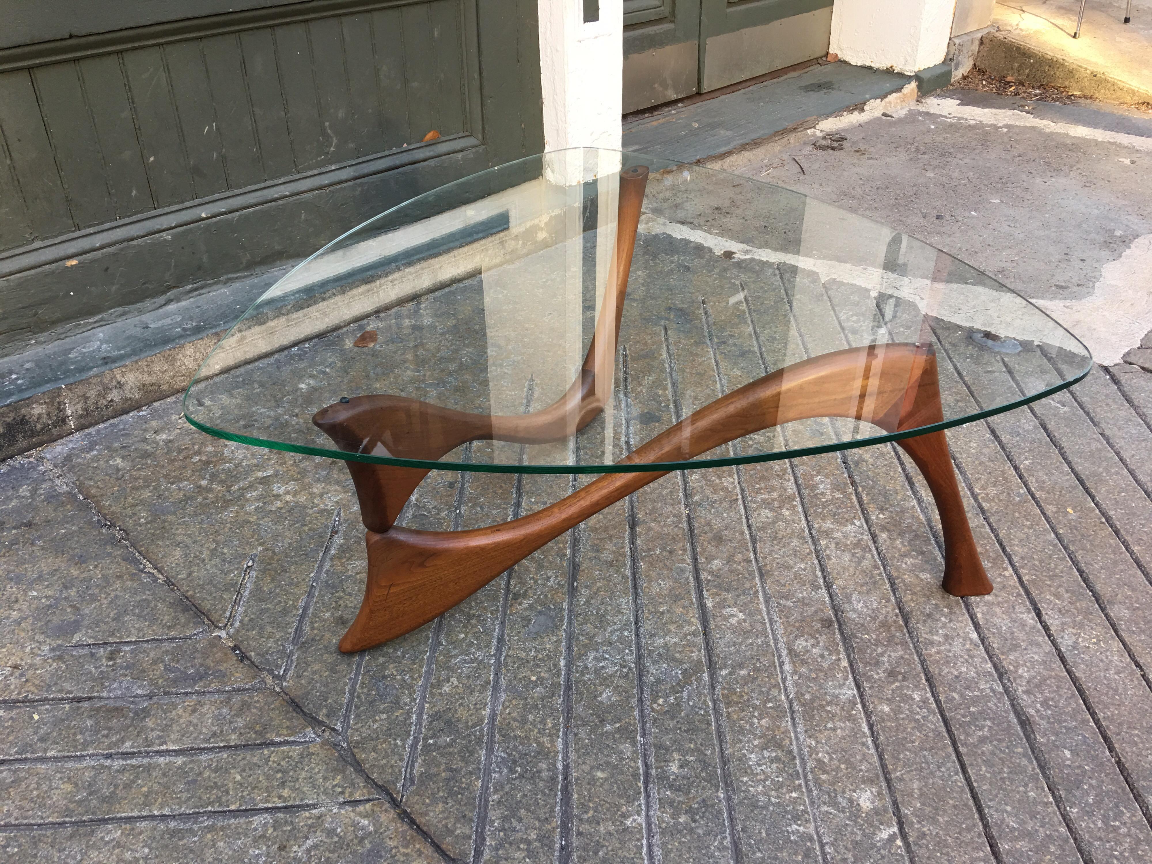 Sculptural teak coffee table with triangular top. Different interpretation of a Noguchi Design. Unique 2 part interlocking base supports glass.