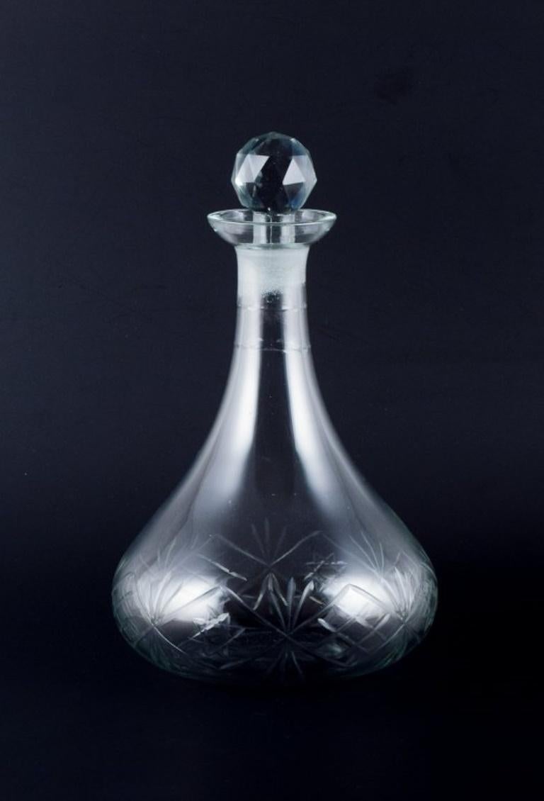 Mid-20th Century Danish glasswork, wine decanter in clear glass. Ball-shaped faceted stopper. For Sale