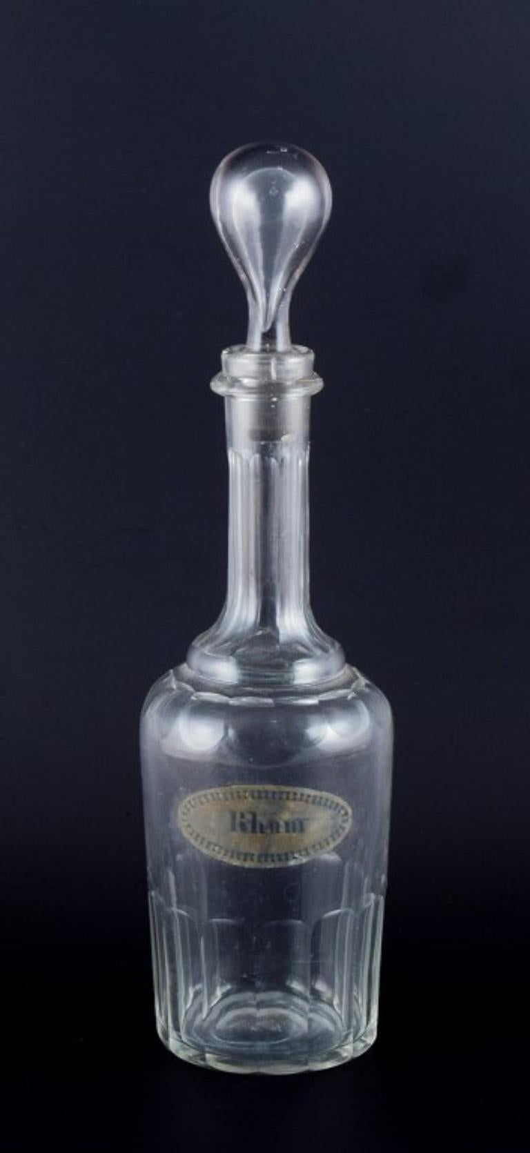 Dänische Glashütte, Karaffe für Rum aus klarem mundgeblasenem facettiertem Glas.
1930er/1940er Jahre.
In ausgezeichnetem Zustand.
Mit einem eingravierten Label, auf dem 