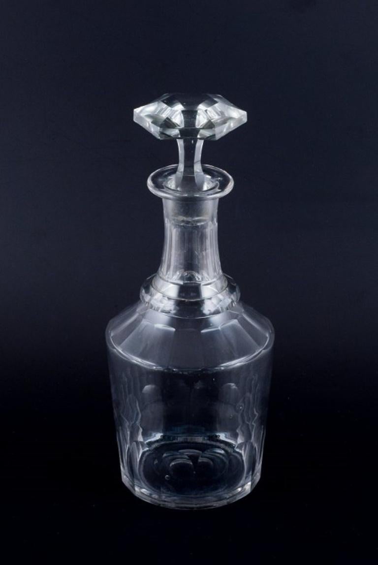 Danish glassworks, hand-blown wine decanter in clear faceted cut glass.
1930s/40s.
In very good condition with some chips in the bottom of the stopper and on the bottom of the decanter.
Dimensions: H 25.0 x D 9.5 cm.