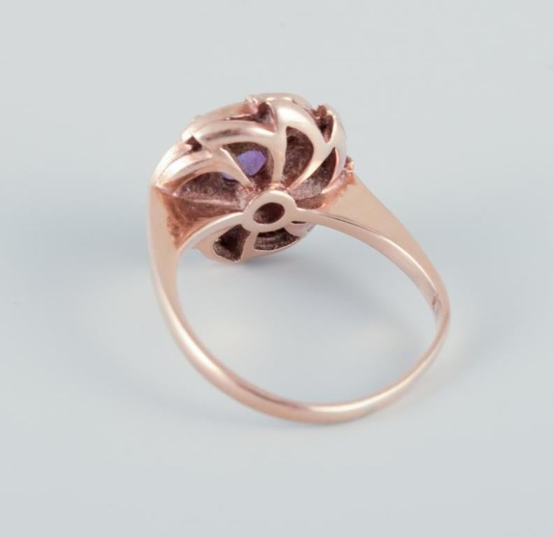 Danish goldsmith, 14 karat gold ring adorned with a purple semi-precious stone.  1