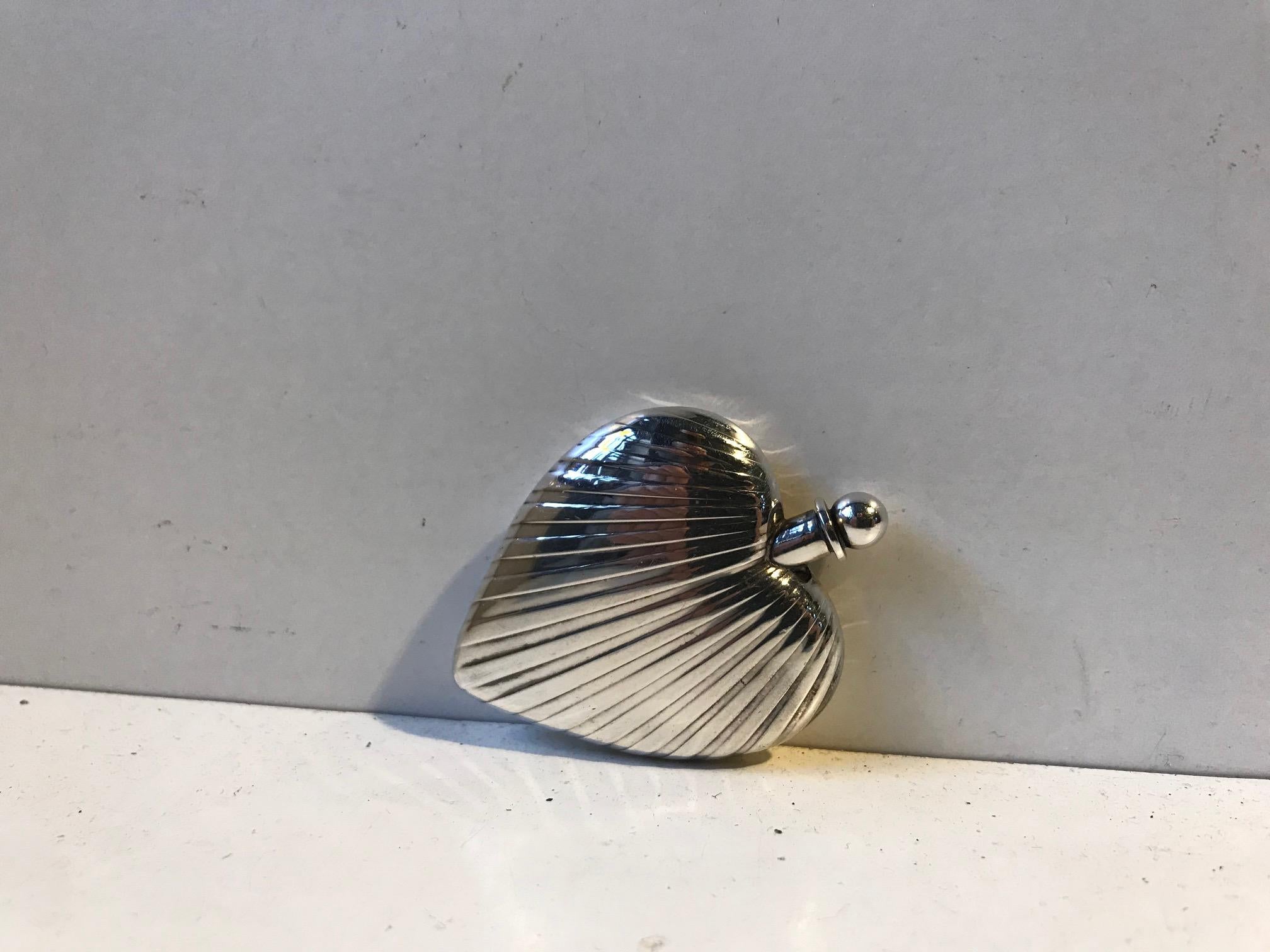 Exquisite heart shaped Tabatiére executed during the 1930s by the Danish Silversmith Hans Jensen, Aarhus, Denmark. It is made from hallmarked 830/1000 silver and bears the initials of the designer. It distinct Art Deco styling mimics the pattern of