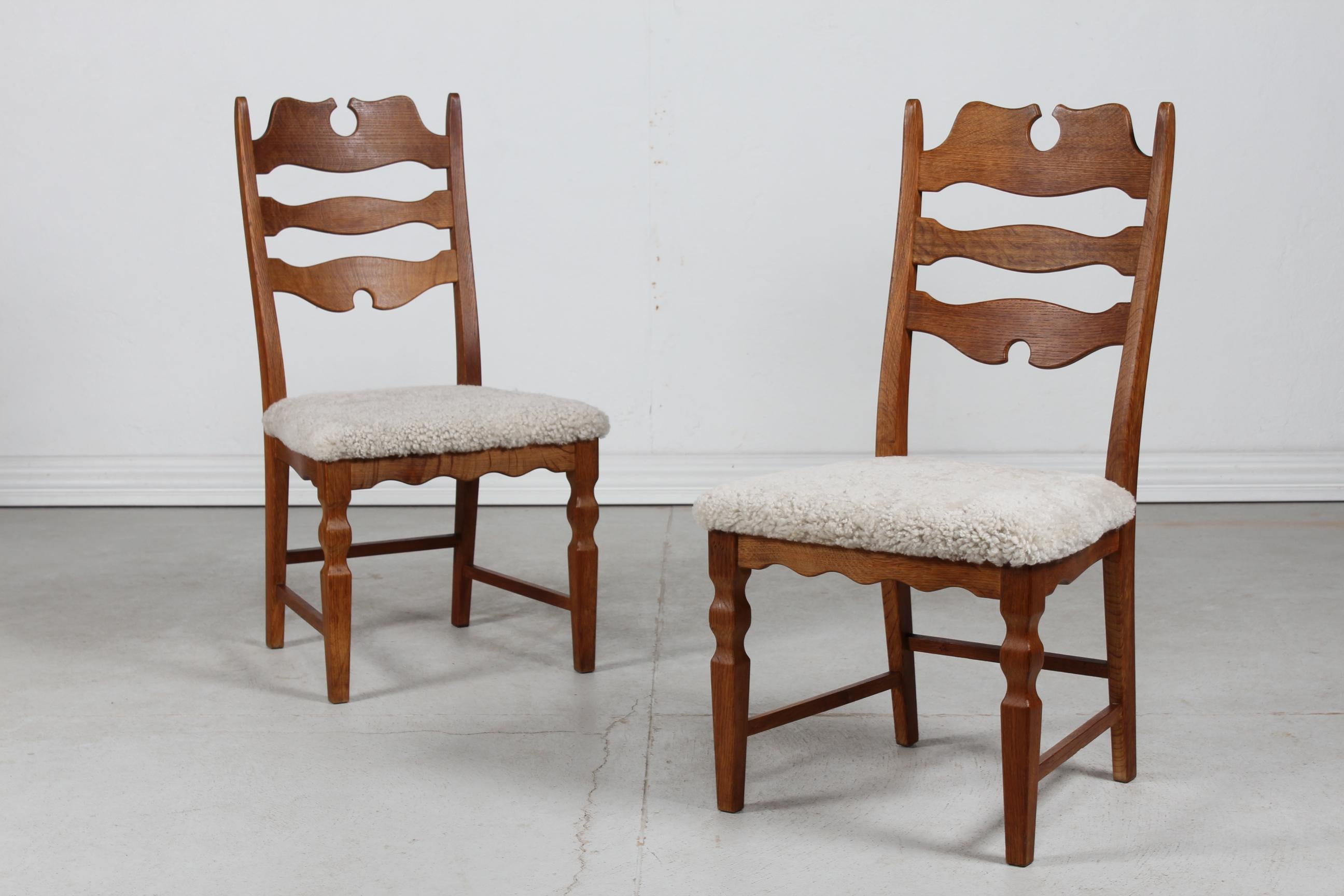 Pair of Danish vintage Henning Kjærnulf high razorblade chairs from the 1970's.
They are made of solid patinated oak upholstered with new sheep skin 
This type is very comfortable to sit on.

Paperlabel Manufactorer: EG Møbler

Very good vintage