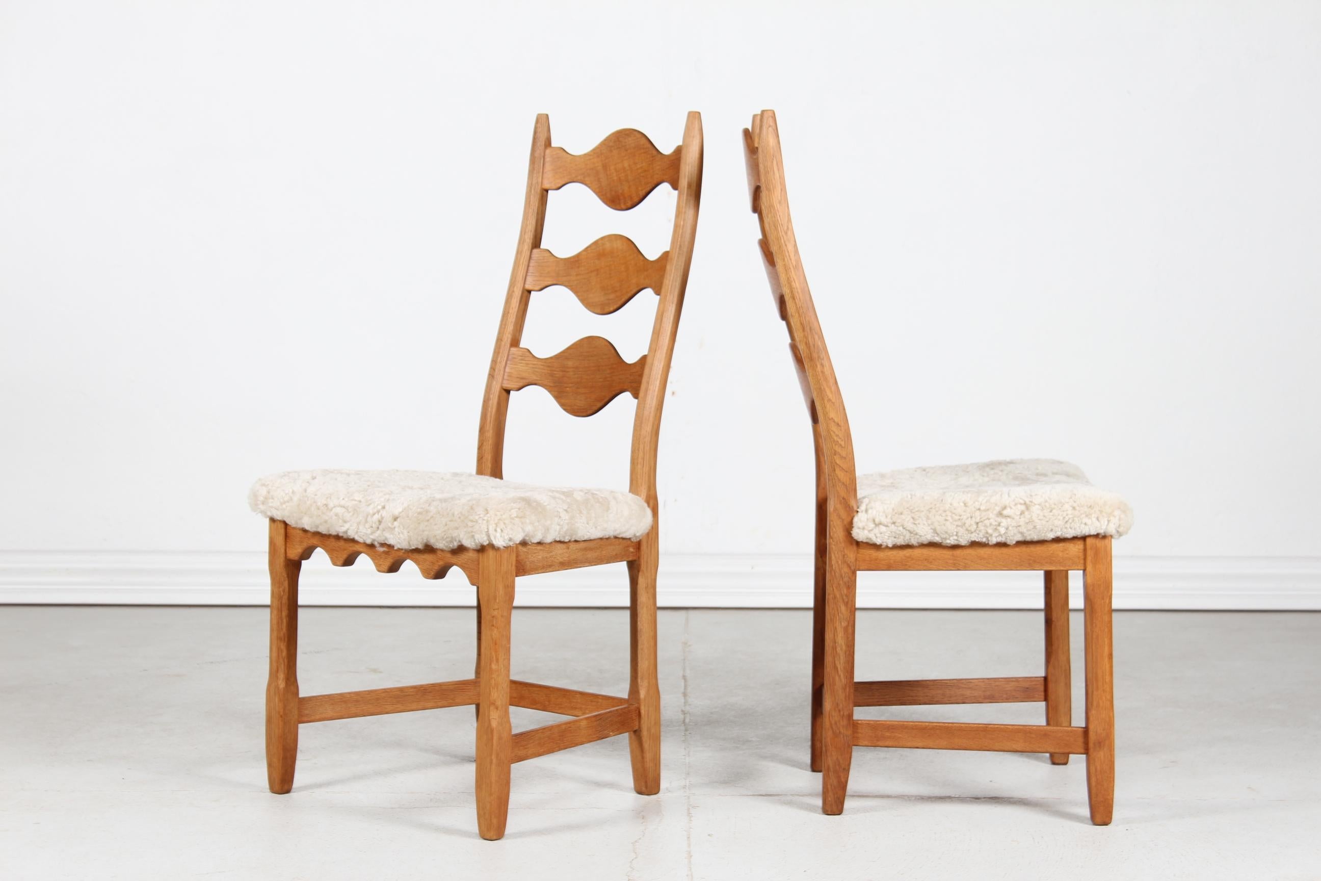 Here is a set of 2 Danish vintage chairs in great country style. 
They are designed by Henning Kjærnulf and manufactured by the Danish company EG Furniture.
The chairs are made of solid oak with high backrest. 
The seats are upholstered with new