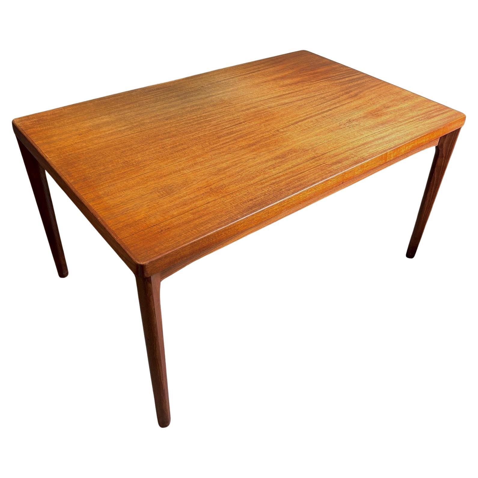 A beautiful Danish extending teak dining table by Henning Kjærnulf for Vejle Møbelfabrik, this would make a stylish addition to any dining or work area. A striking piece of classically designed Scandinavian furniture.

The table has two pull out