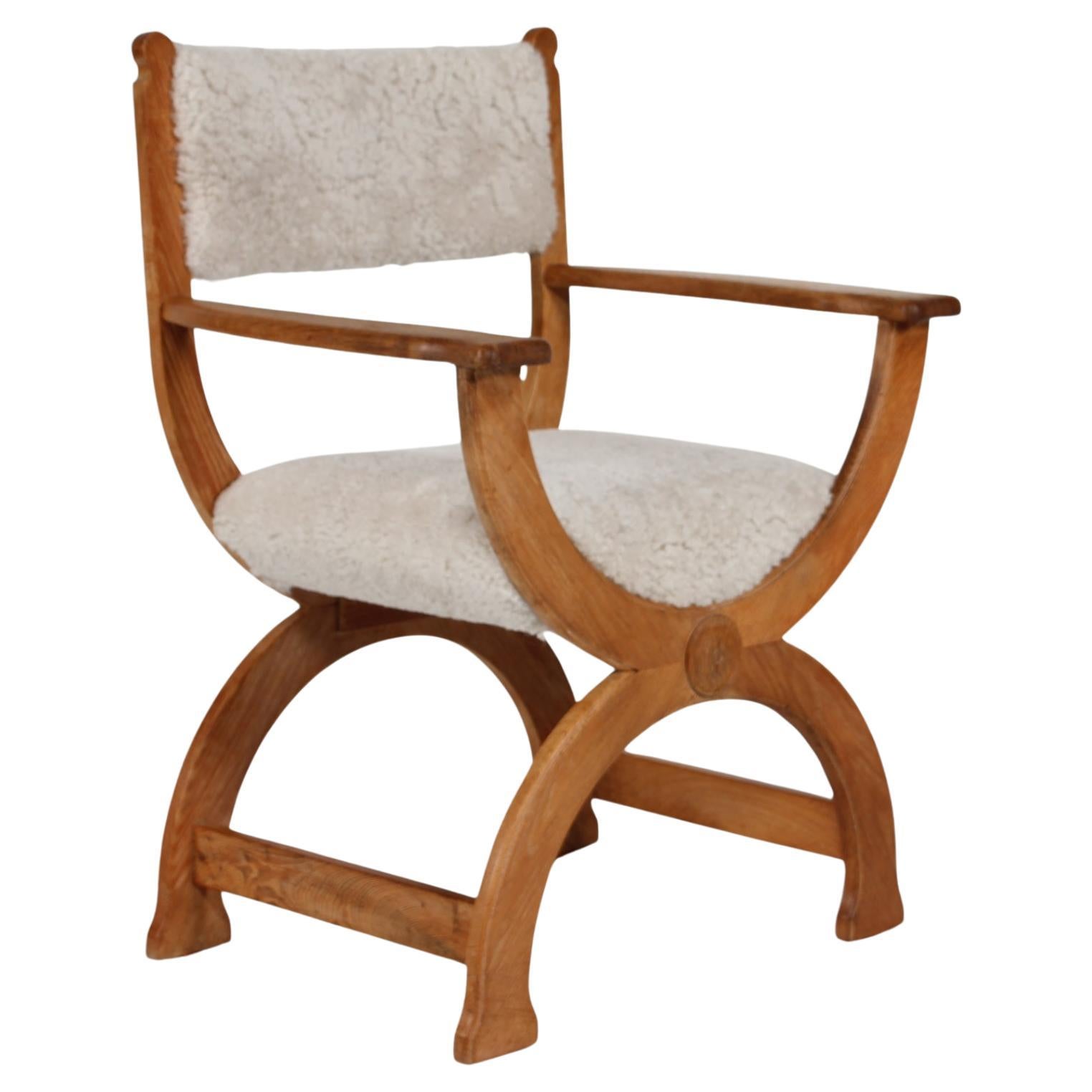 Danish vintage Henning Kjærnulf Kurul armchair skilled crafted by EG Møbler in Denmark

The chair is made of solid oak upholstered with new sheepskin which is very comfortable and 