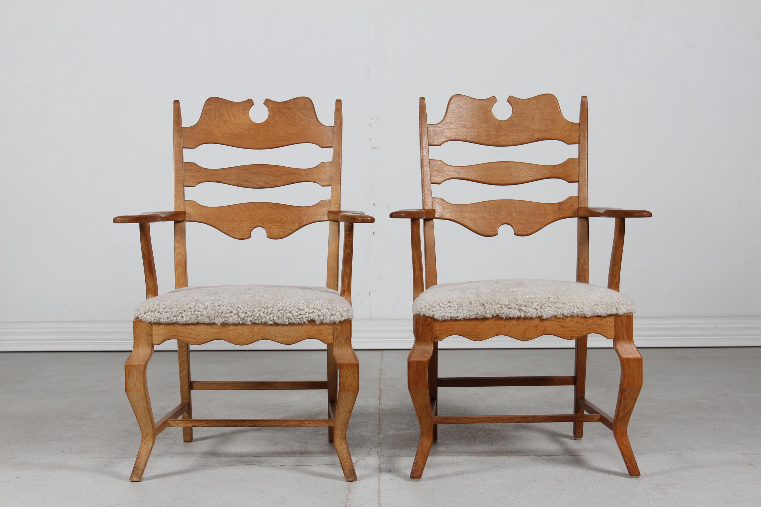 A pair of Danish vintage Henning Kjærnulf razor blade armchairs manufactured by EG Furniture in Denmark.

The chairs are made of solid patinated oak with high backrest. The seats are upholstered with new sheepskin which is very comfortable to sit