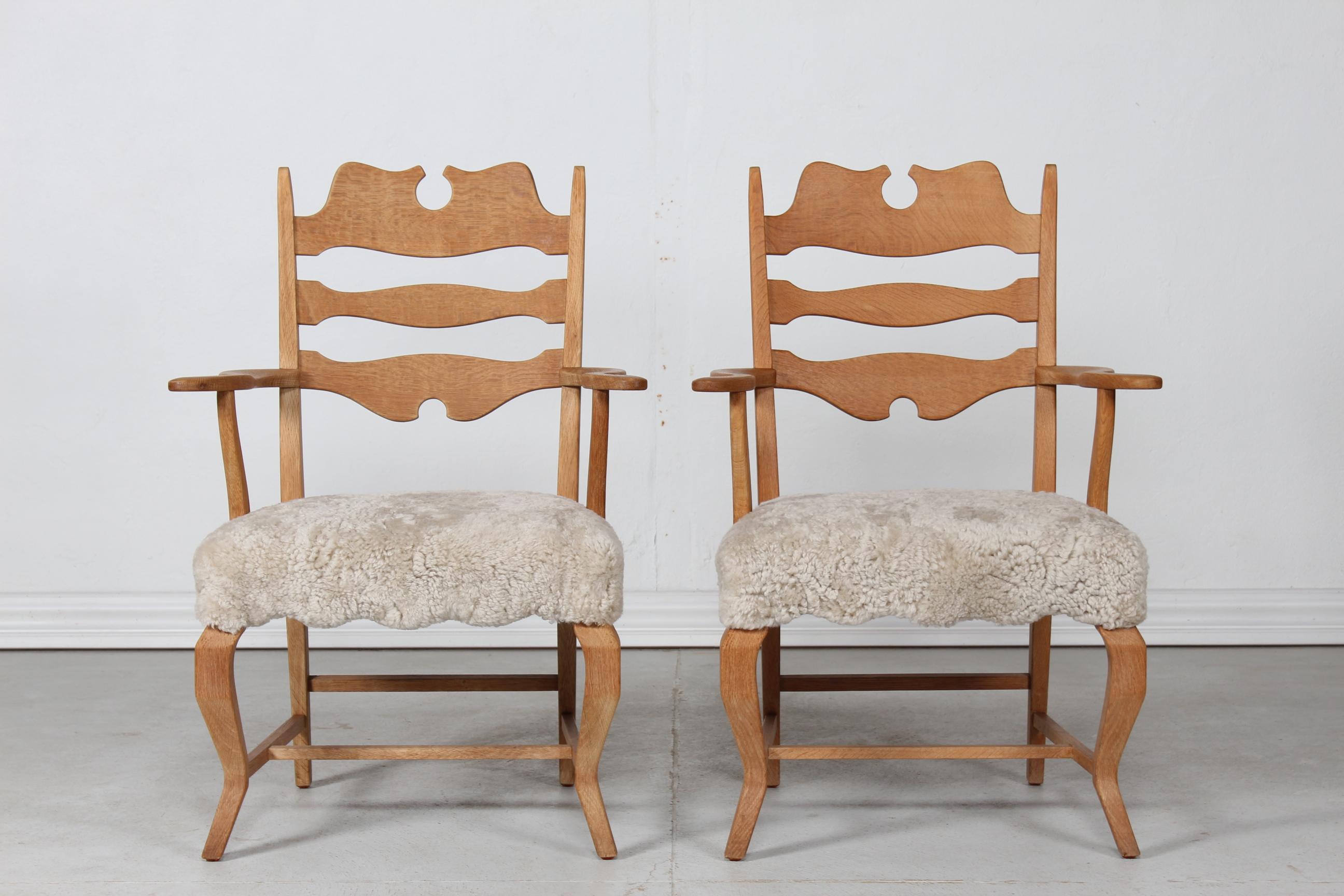 A pair of Danish vintage Henning Kjærnulf razor blade armchairs manufactured by EG Furniture.

The chairs are made of solid oak with high backrest. The seats are upholstered with new sheepskin which is very comfortable to sit on.

Nice vintage