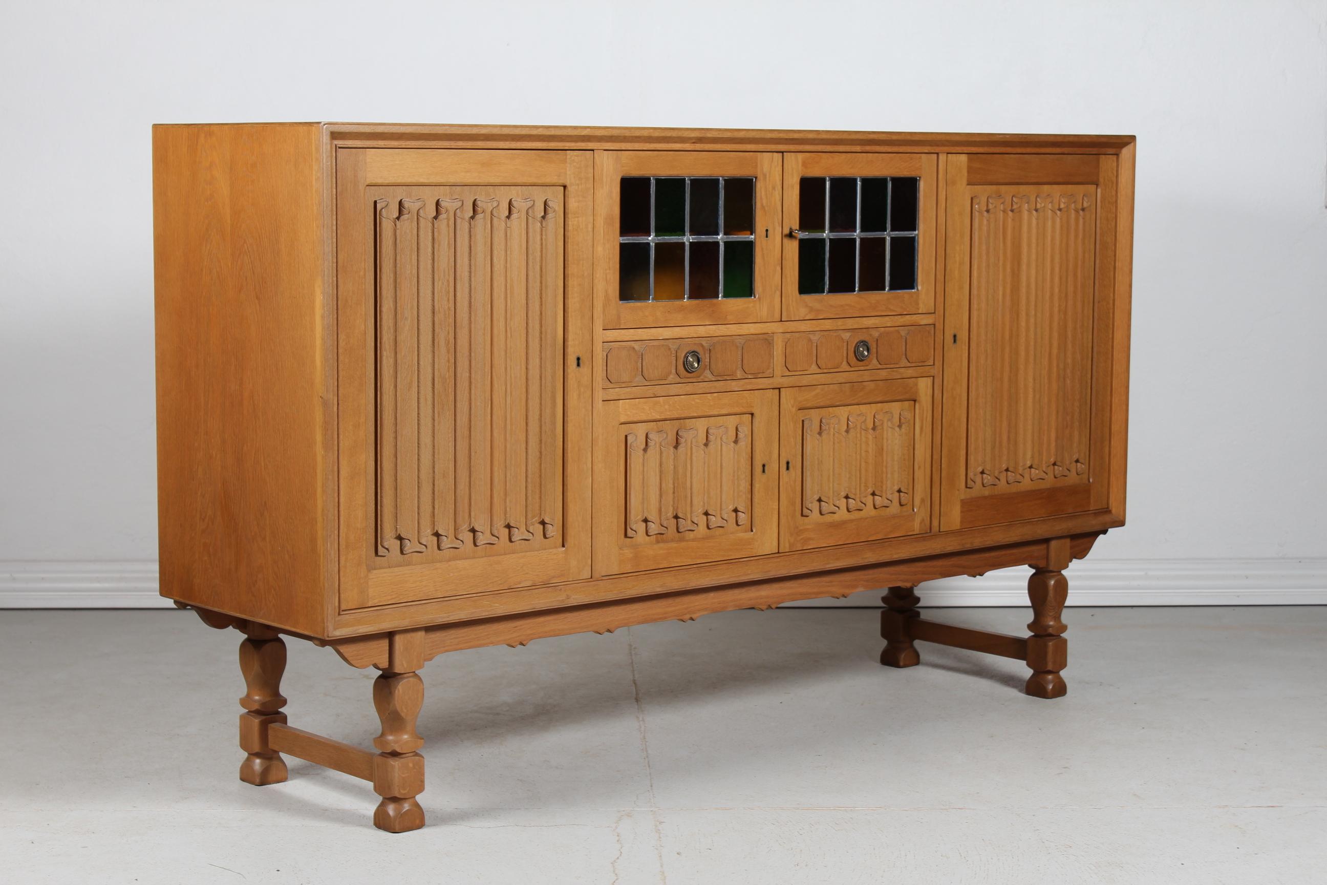 Long sideboard in the style of designer Henning Kjærnulf (perhaps by him) and most likely manufactured by the Danish company Nyrup Møbelfabrik/ EG Furniture, Denmark in the 1970s.

The country style sideboard is made of solid- and veneered oak with