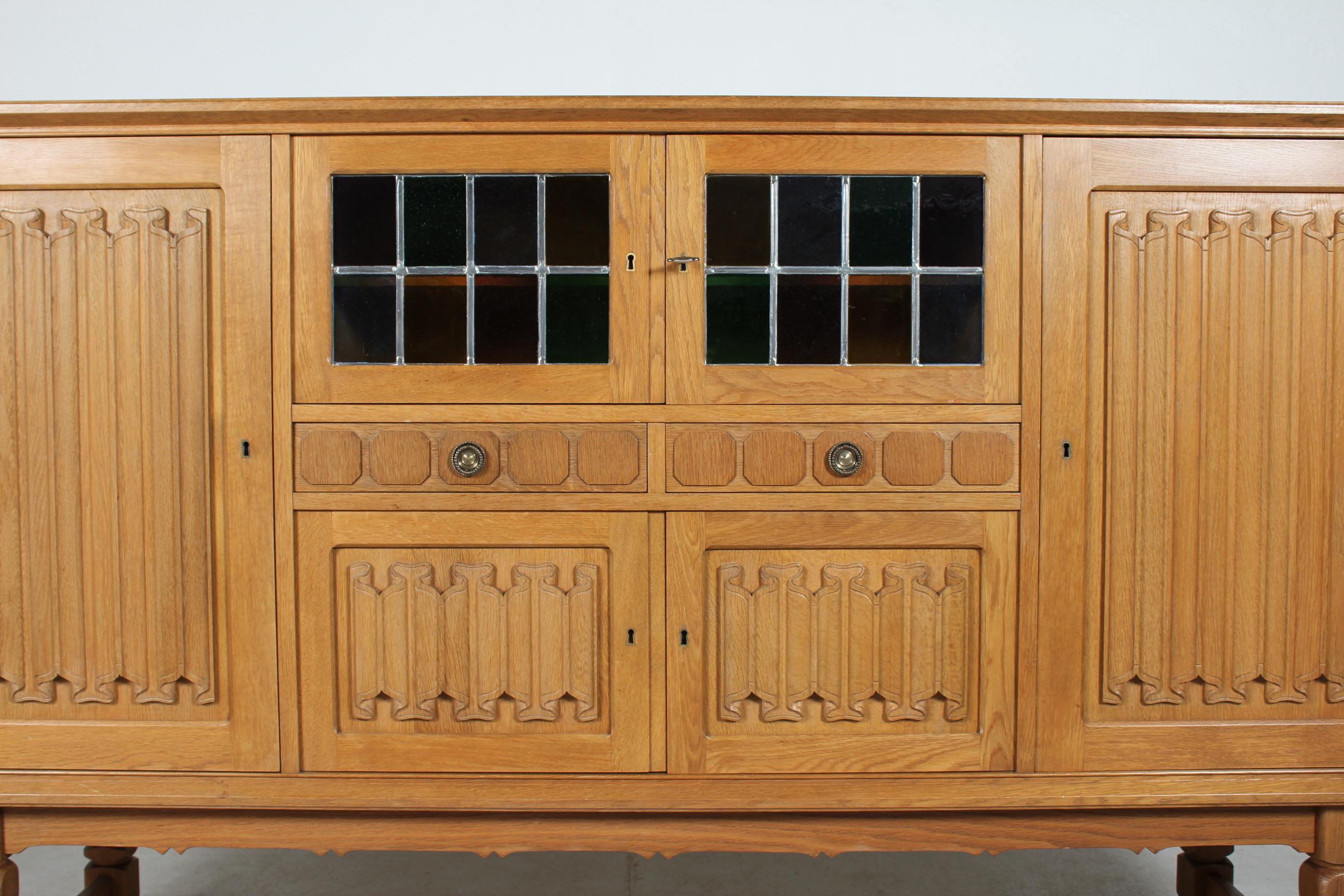 Danish Henning Kjærnulf style Long + High Sideboard of Solid carved Oak 1970s In Good Condition In Silkeborg, Silkeborg