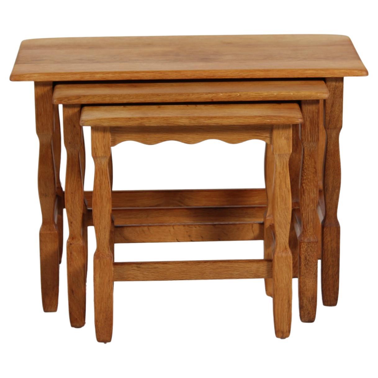Set of nesting tables in the style of Henning Kjærnulf (if not by him) and most likely manufactured by the Danish company Nyrup Møbelfabrik/ EG Furniture, Denmark in the 1970s.

The tables are made of solid oak with wood carvings on the legs and can