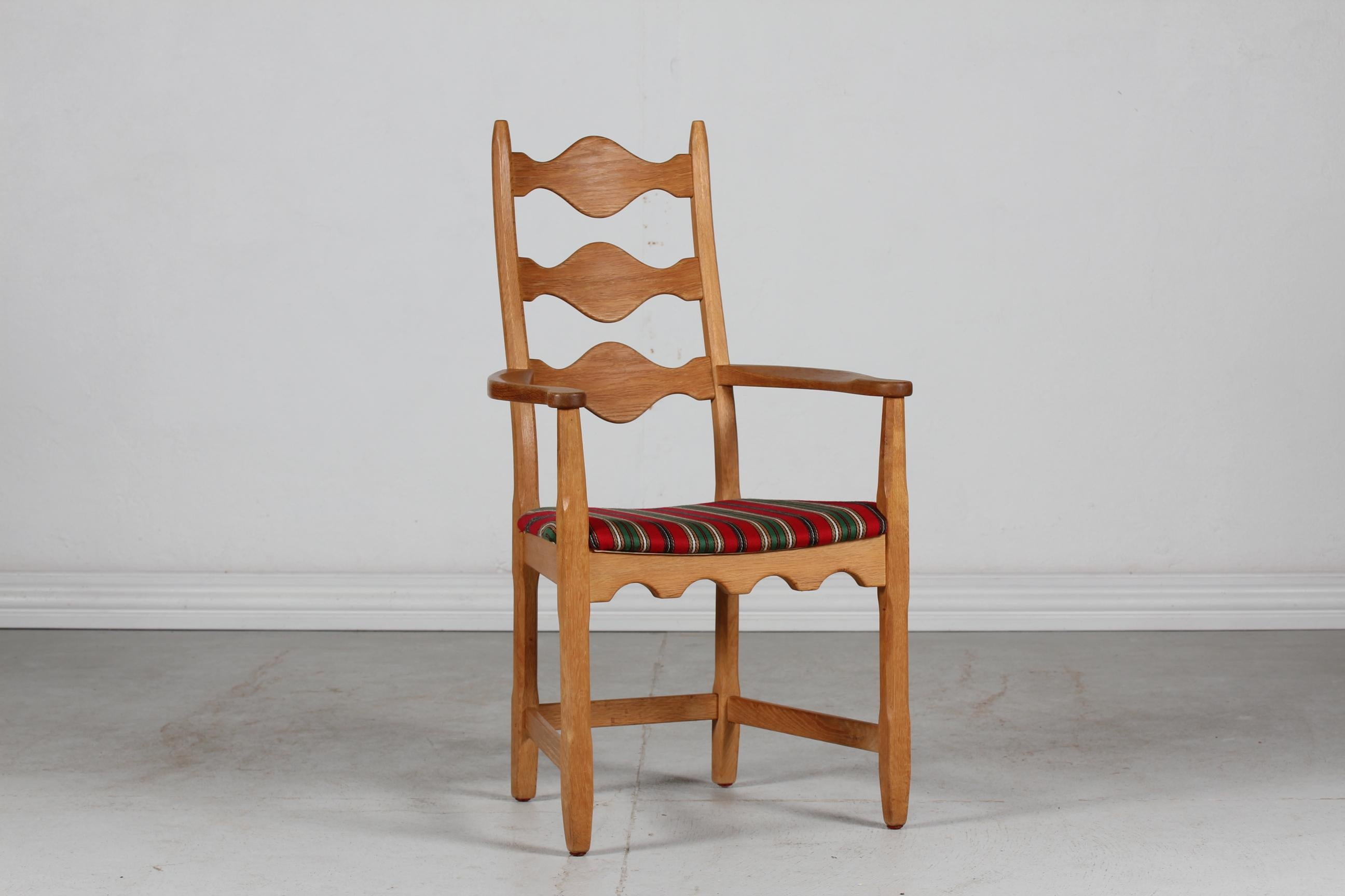Danish vintage sculptural brutalist Henning Kjærnulf style tall armchair from the 1970's.

The chair is made of solid oak upholstered with striped woolen fabric in green, red, white and brown colors.

Nice vintage condition after normal use.
 