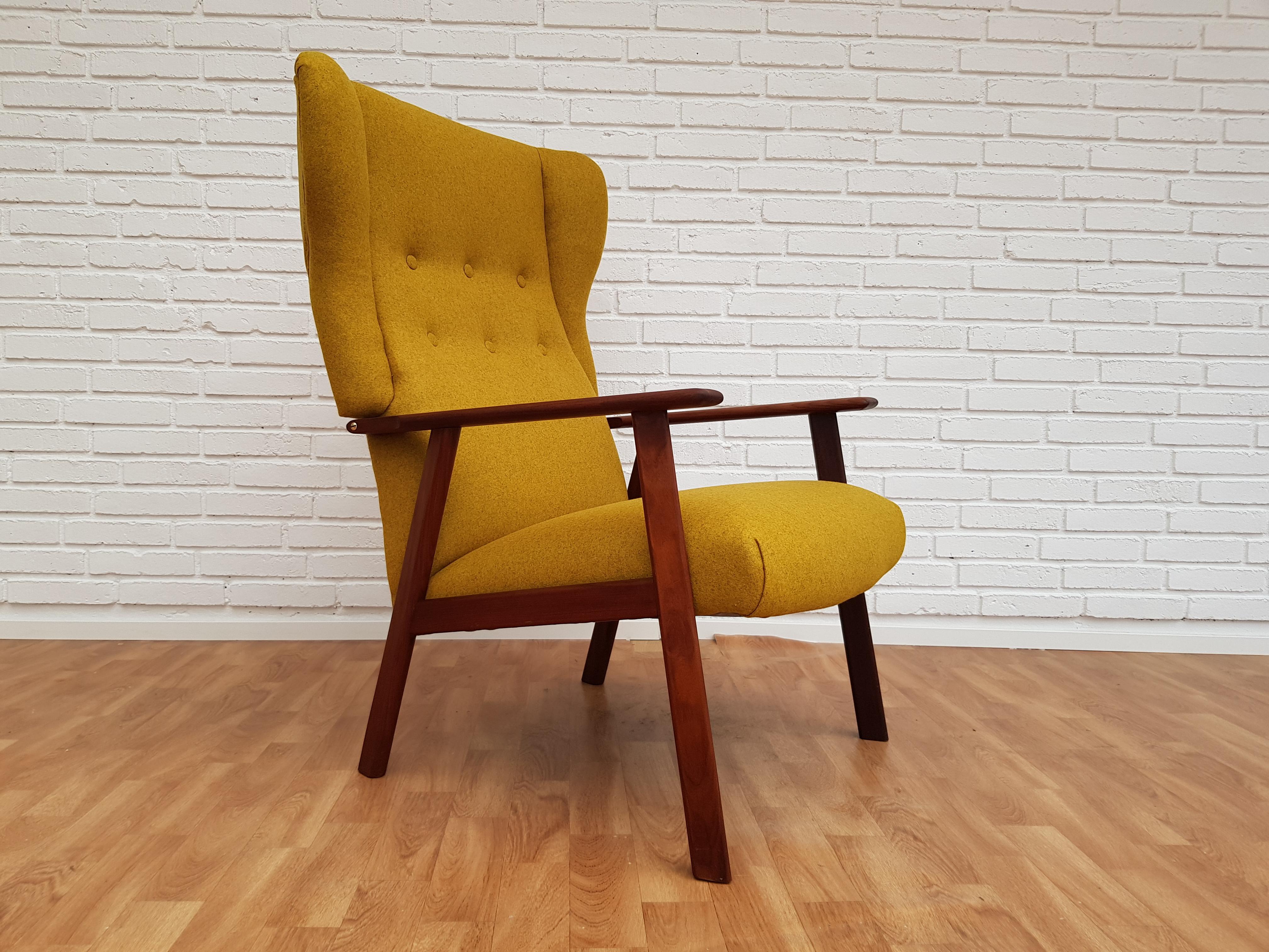 Danish designed high-back armchair with footstool. Produced in about 1970 by the Danish furniture manufacturer. Solid teak wood. Completely renovated by craftsman, furniture upholsterer at Retro Møbler Galleri. Brand new padding with natural coconut