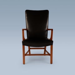 Danish high back black leather armchair with mahogany frame