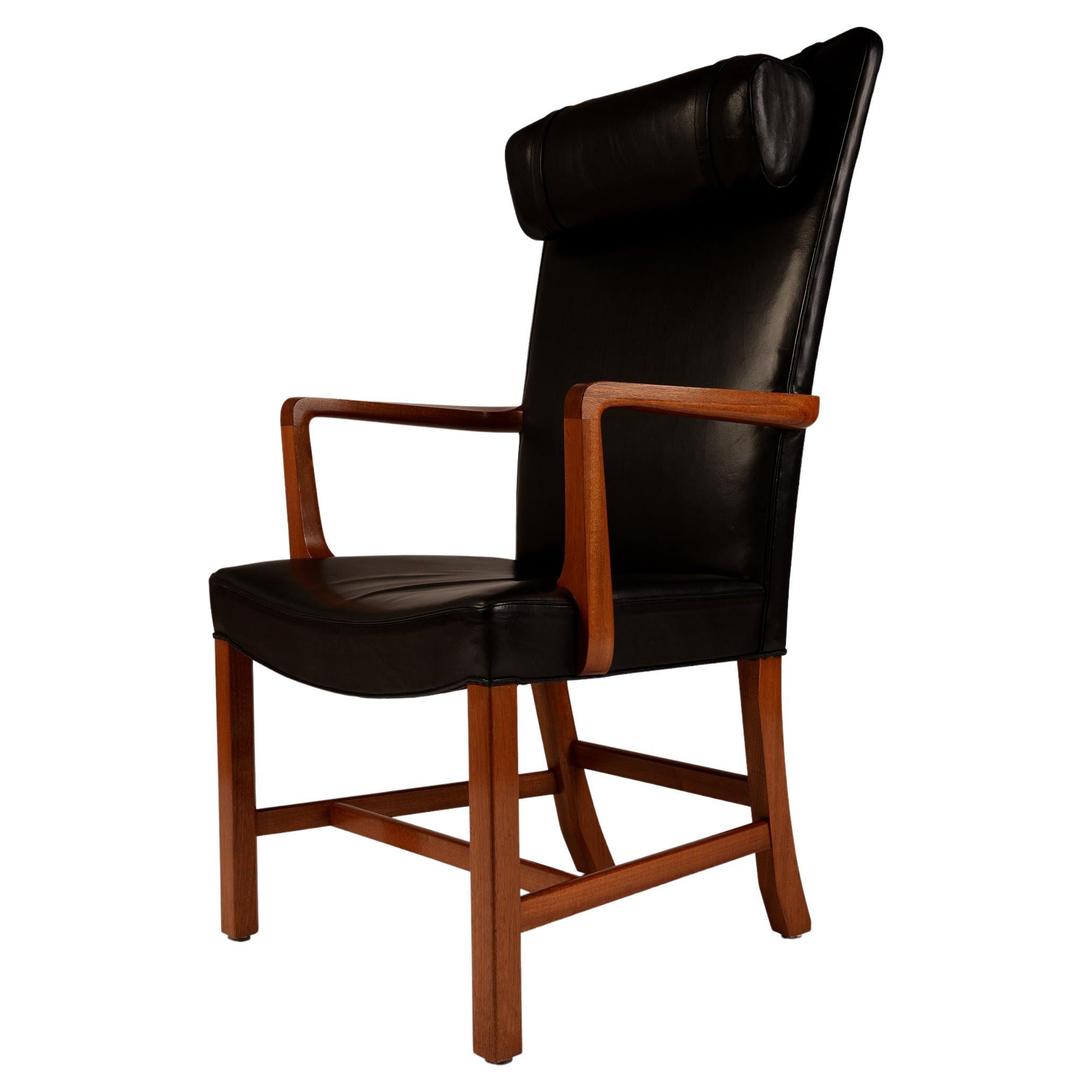 Danish high back black leather armchair with mahogany frame For Sale