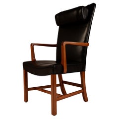 Vintage Danish high back black leather armchair with mahogany frame