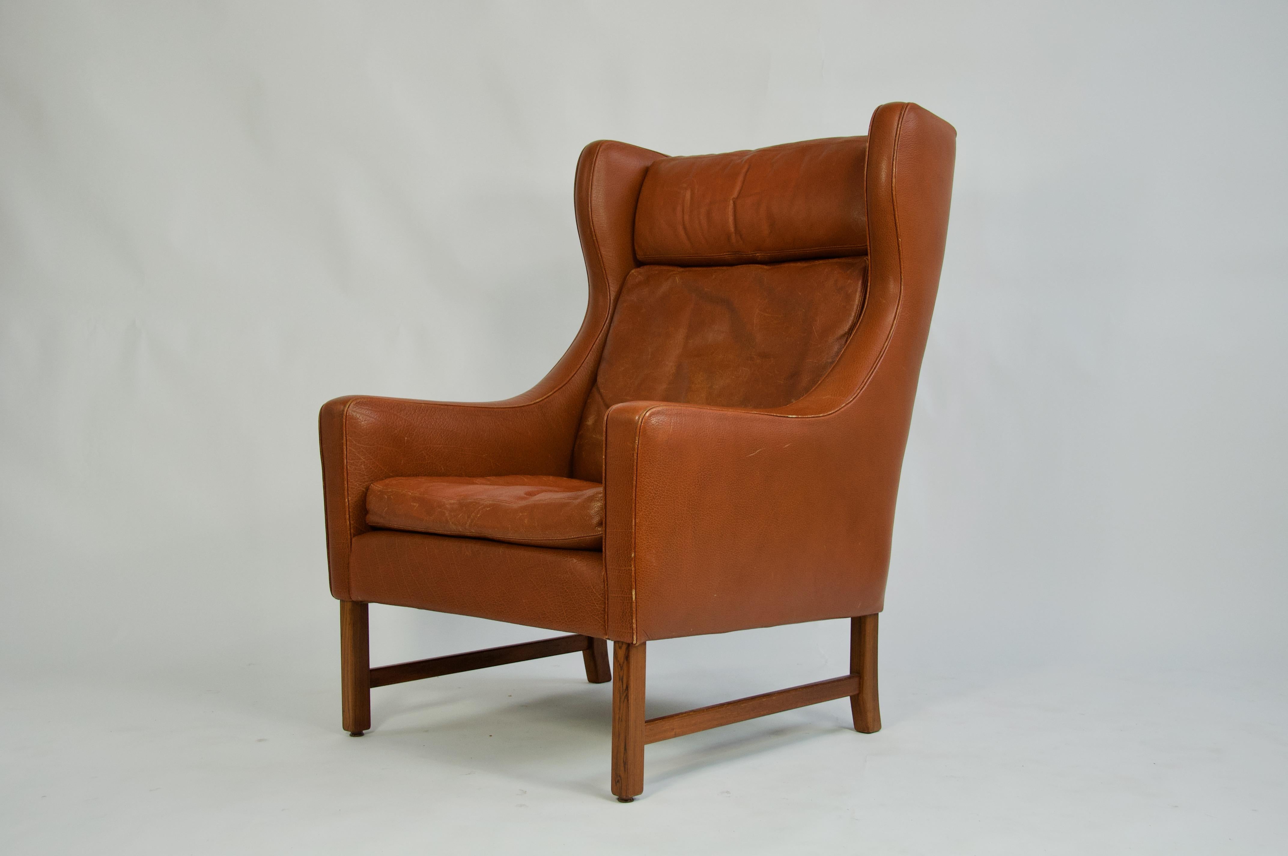 Danish high back leather chair with rosewood base.