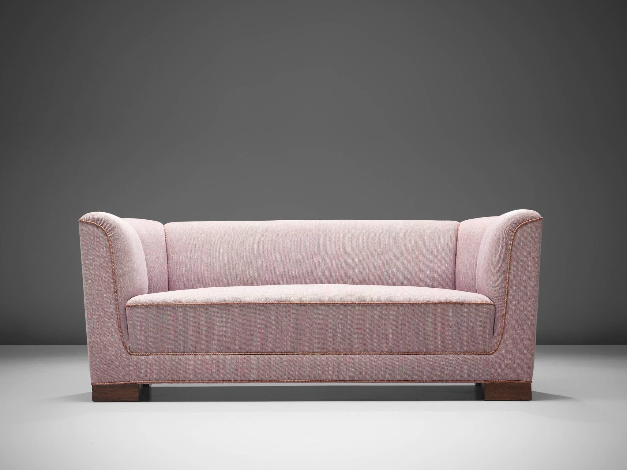 Danish cabinetmaker, three-seat sofa, pink wool, rosewood, Denmark, 1950s.

Simplistic and strong Danish sofa with clean lines and a high back. The sofa features thick, veneered rosewood legs. The piece is thick and comfortable and is finished