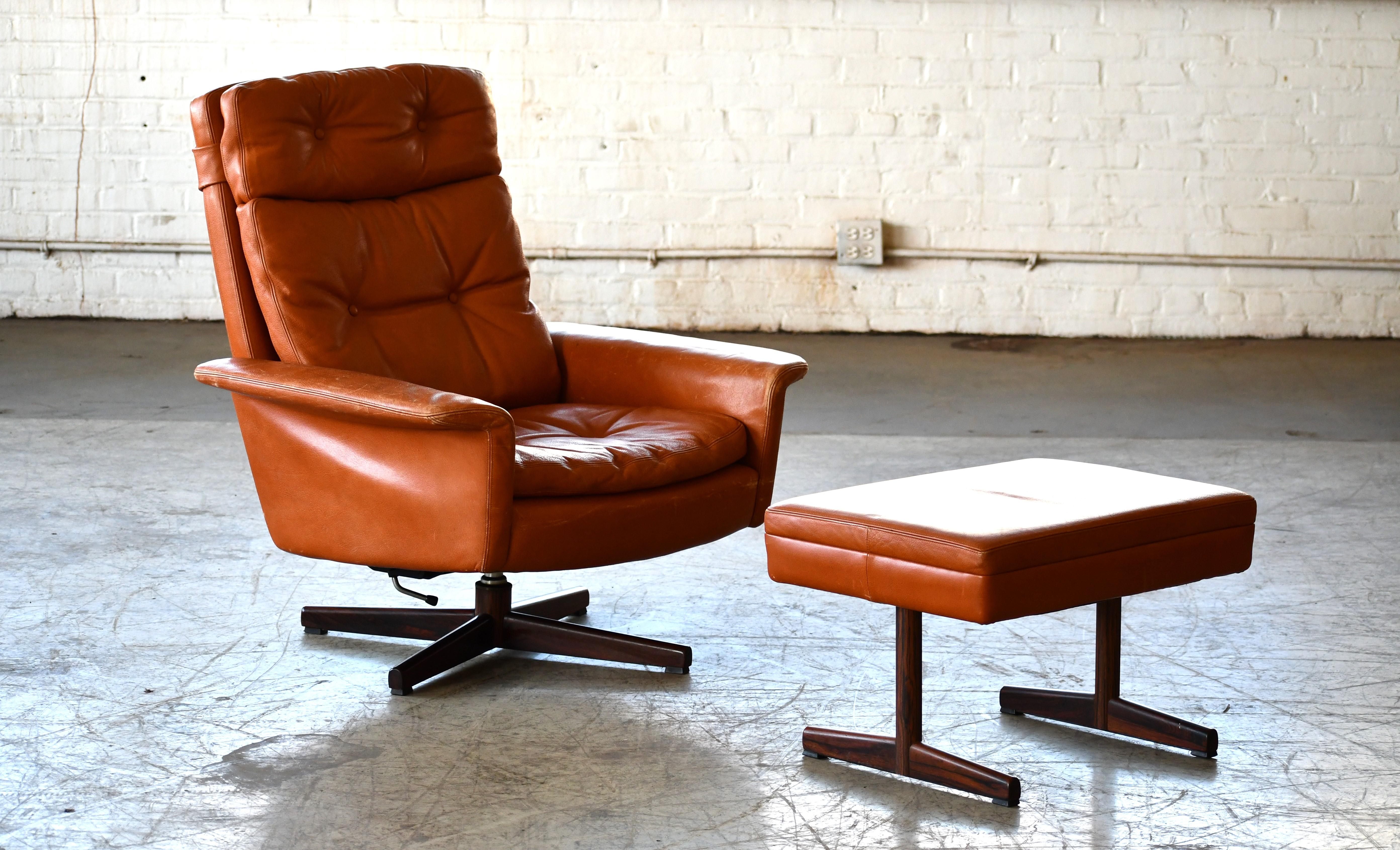 Mid-Century Modern Danish High Back Swivel Lounge Chair with Ottoman in Cognac Leather, 1970's For Sale