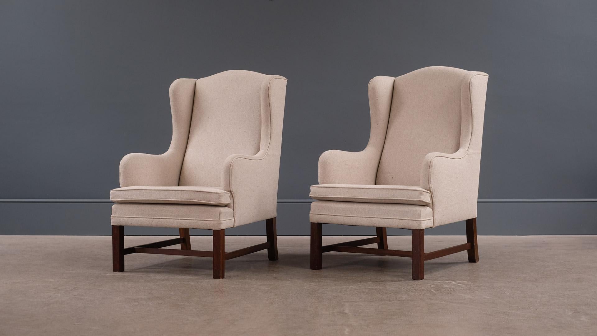 Very elegant and super comfortable high back Danish armchairs in the manner of Kaare Klint. Fully refurbished and reupholstered.