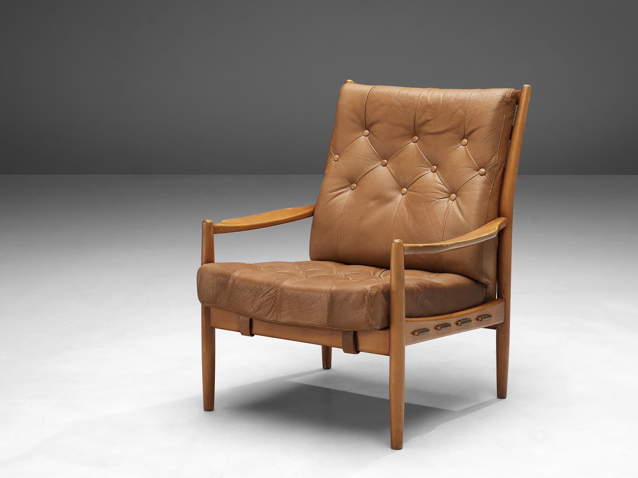 Armchair, beech, leatherette, Danish, 1960s. 

This stately and well-executed Danish high back armchair shows an exquisite level of craftsmanship. The lines and finishes in this item are both curvy and crisp. The frame shows traits of the