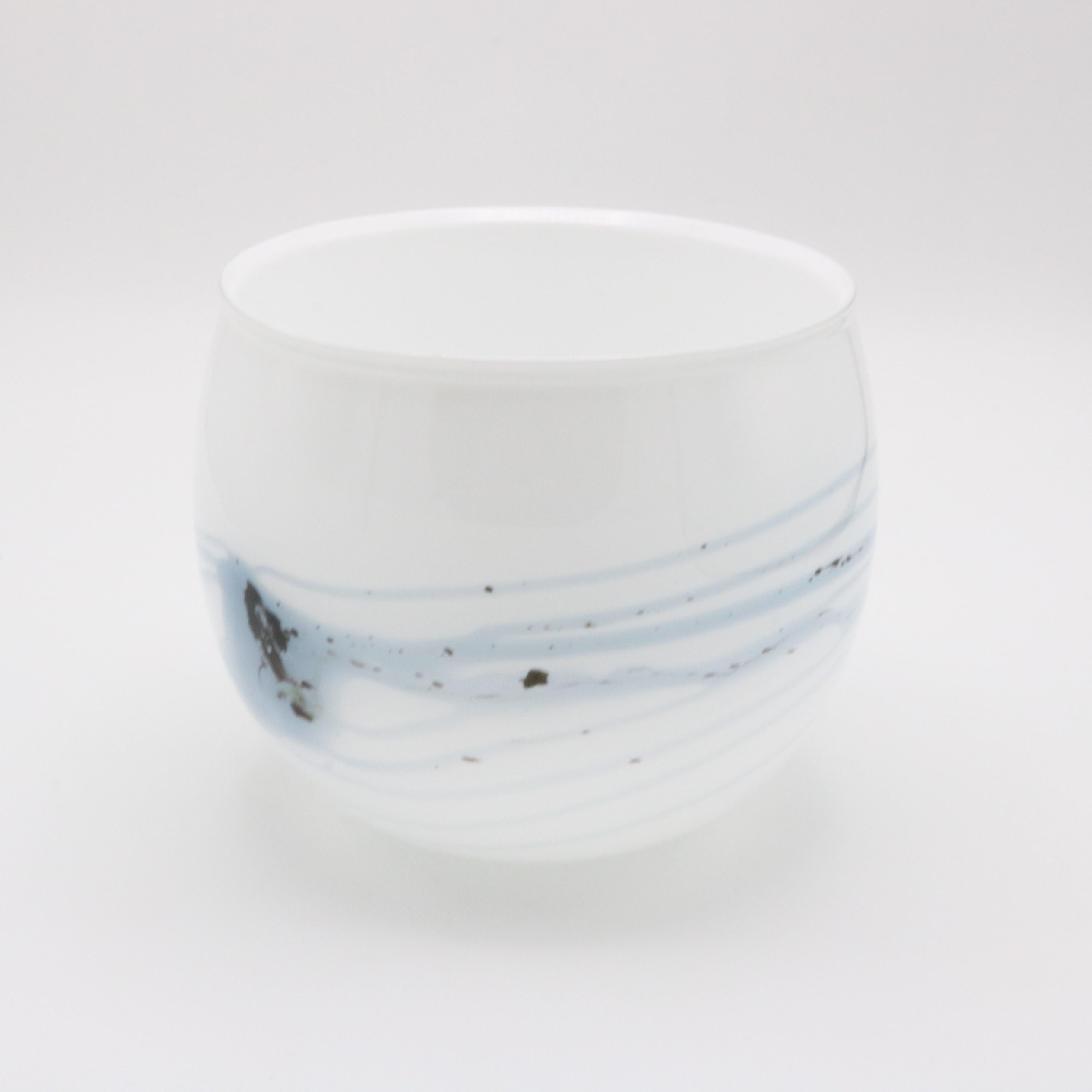 A Danish Holmegaard glass cache pot designed by Michael Bang from Denmark circa 1970. This unique opaque glass cache pot (literally “hiding pot” in English) features blue colored swirl patterns visible from every direction.