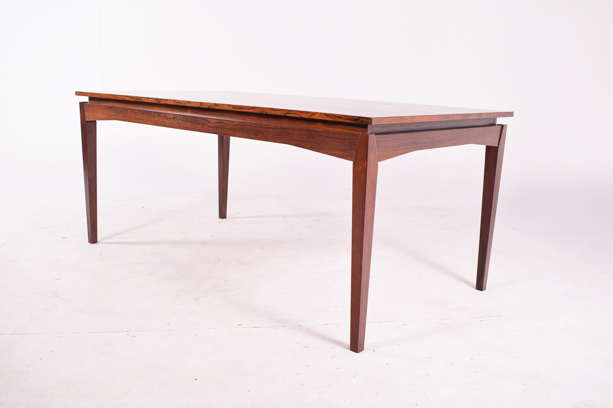 Danish rosewood extendable dining table designed by H.W. Klein for Bramin. Fantastic design. This rectangular table extends on the end with two extension leaves with 55 cm each. Extensions stored inside table. Very pratical table has you have the