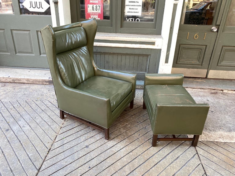 High back green leather wingback and ottoman. Set dates to the 1960's and shows nice patina! Seat cushion has been repacked, but everything else original. Shows signs of Danish Design Influences but made in Chicago, retains original tags to bottom.