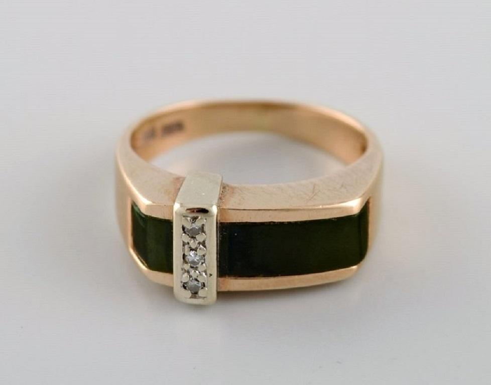 Danish jeweler. Vintage ring in 14 carat gold adorned with green tourmaline and three small diamonds. 
Mid-20th century.
Diameter: 16 mm.
US size: 5.5.
In excellent condition.
Stamped.
In most cases, we can change the size for a fee (USD 50) per