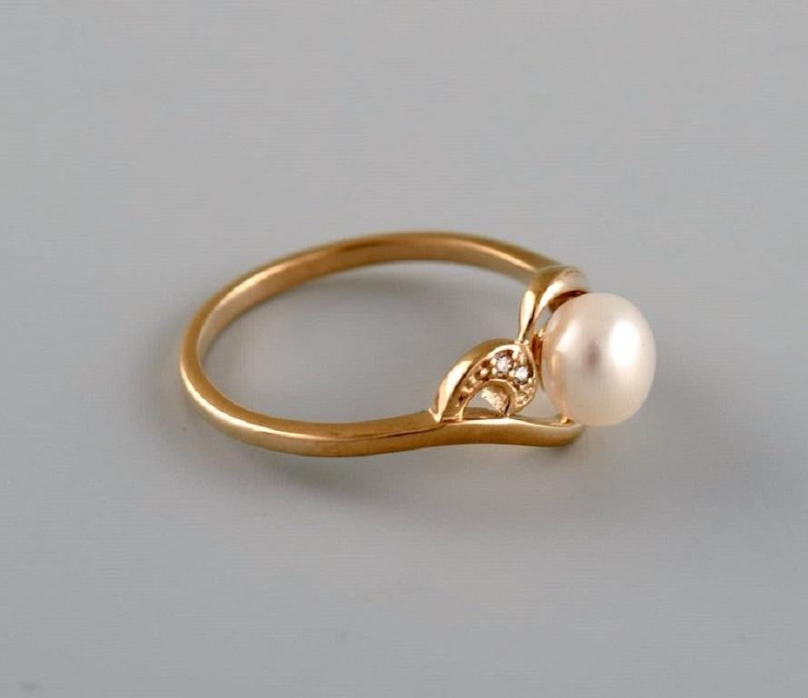 Danish jeweler. Vintage ring in 8-carat gold adorned with cultured pearl and clear semi-precious stones. 
Mid-20th century.
Diameter: 17 mm.
US size: 6.5.
In excellent condition.
Stamped.
In most cases, we can change the size for a fee (USD 50) per