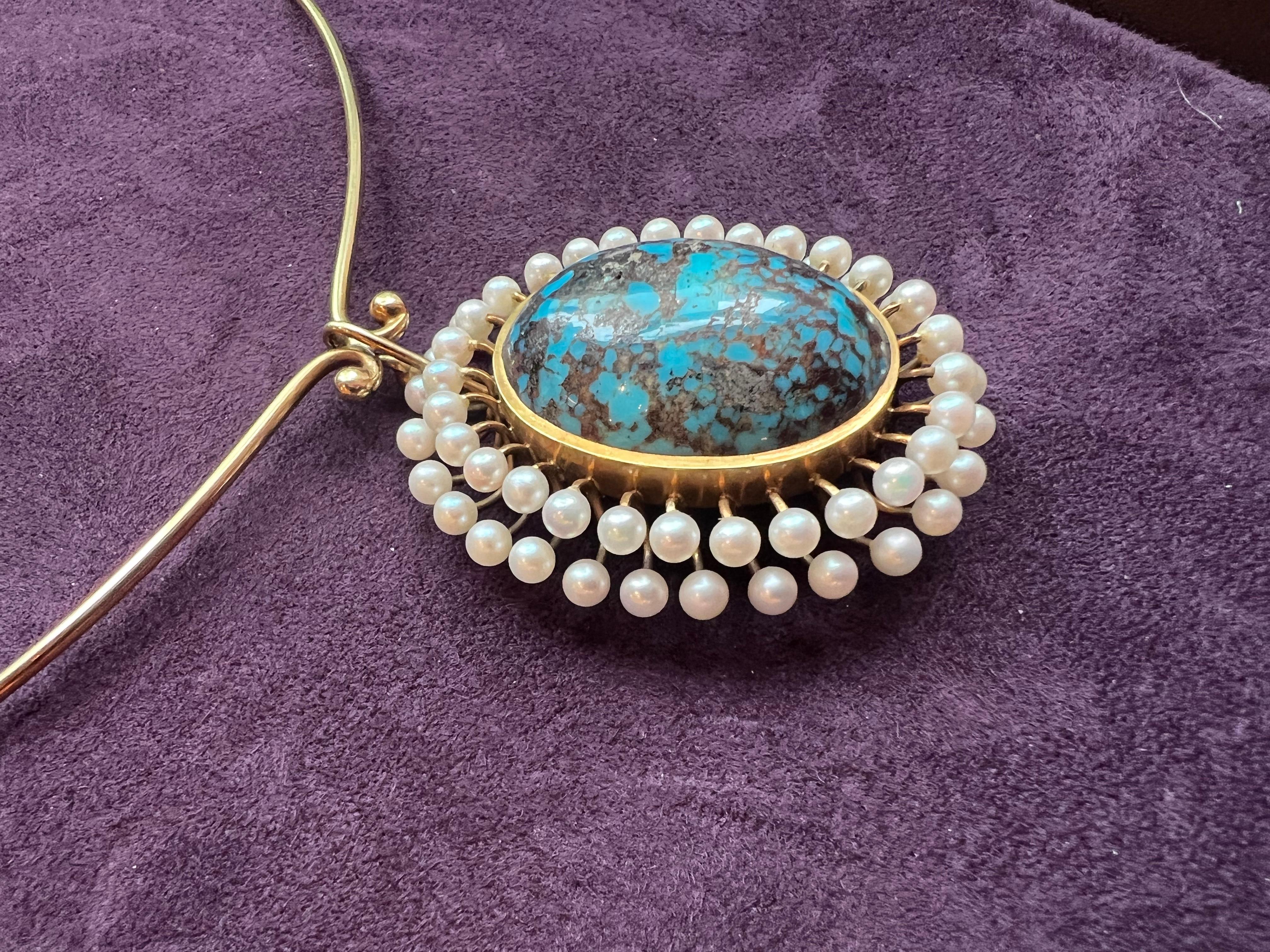 This finely wrought Danish pendant/brooch combination comprises a large oval Persian turquoise, pearls, and 14-karat yellow gold. It was hand fabricated by Jorgen Peter Vang in the 1960s. The neckpiece is a delicate beauty which will enhance any
