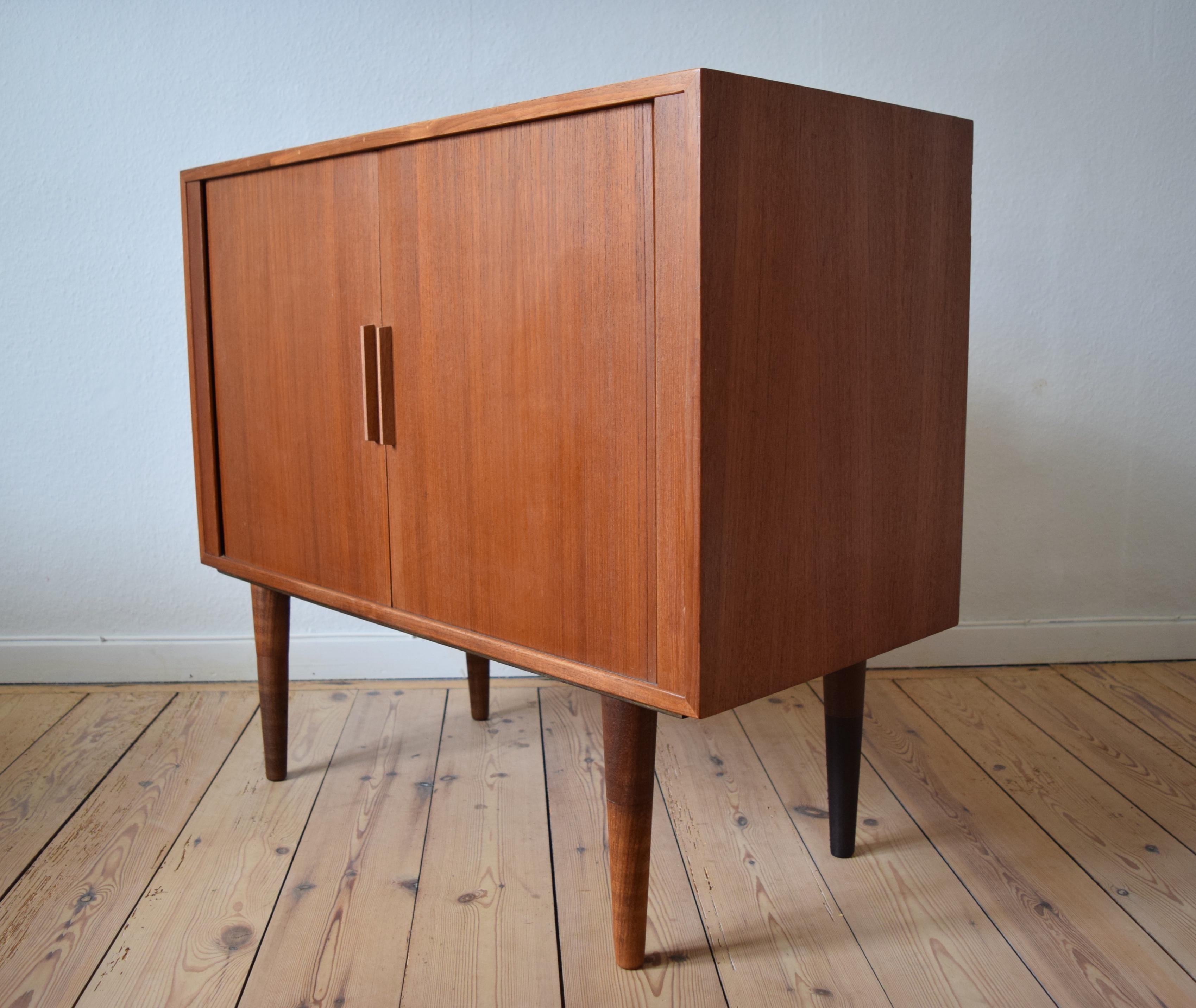 Record player cabinet designed by Kai Kristiansen for FM Møbler in the 1960s. These cabinets have become very popular in the last few years with the increase in vinyl sales recently. Behind the tambour doors there is ample storage space for many