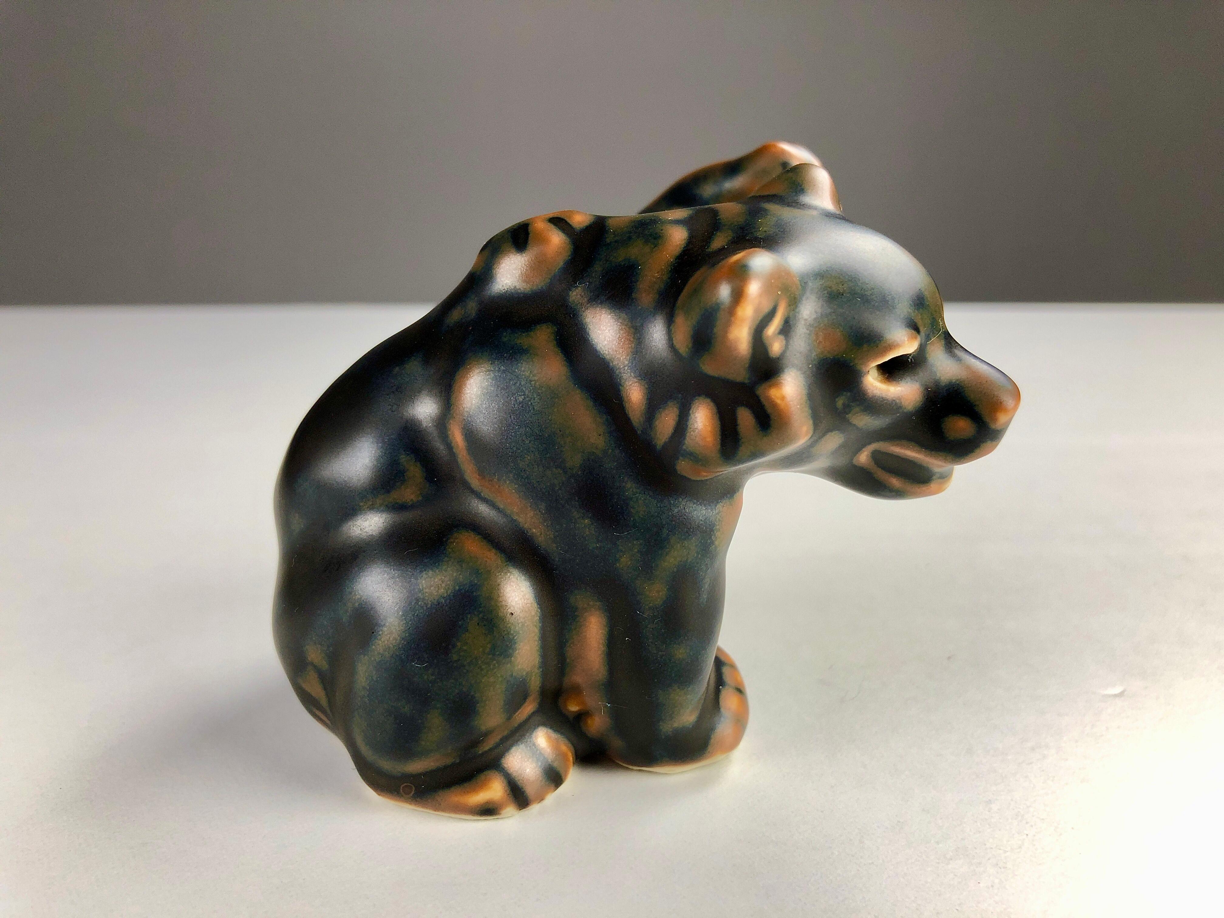 Danish Knud Kyhn baby bear figurine for Royal Copenhagen

The lively figurine of a playing baby bear was created by Knud Kyhn (1880-1969) Knud Kyhn worked for for Royal Copenhagen from 1903-1910, 1924-1932 and 1936-1967. During this period he