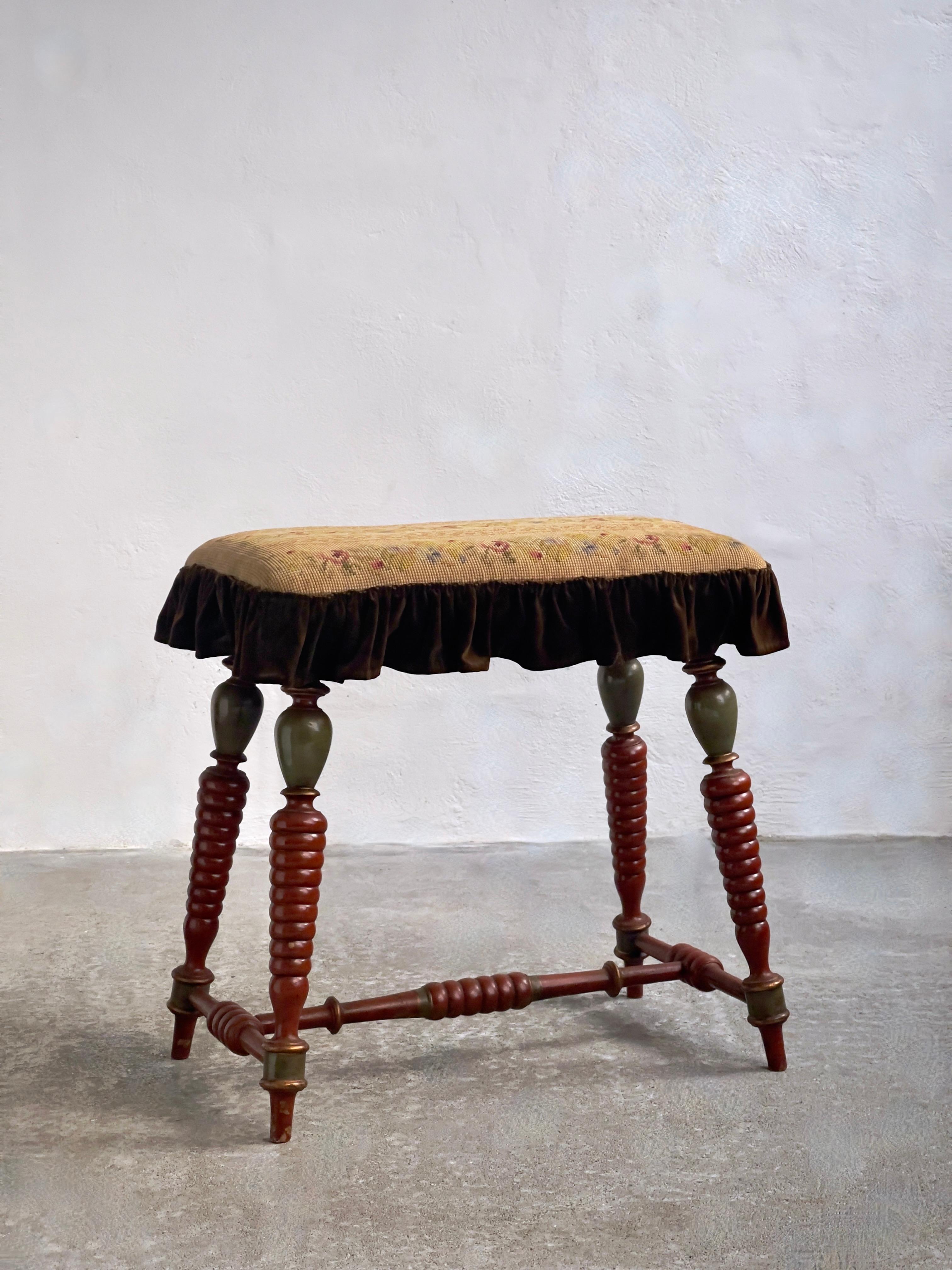 A Tapestry of Danish Artistry: Late 19th Century Stool with Ornately Carved, Painted Legs, and Embroidered Seat.

Nestled within the annals of Danish craftsmanship, this late 19th-century stool emerges as a testament to the intersection of