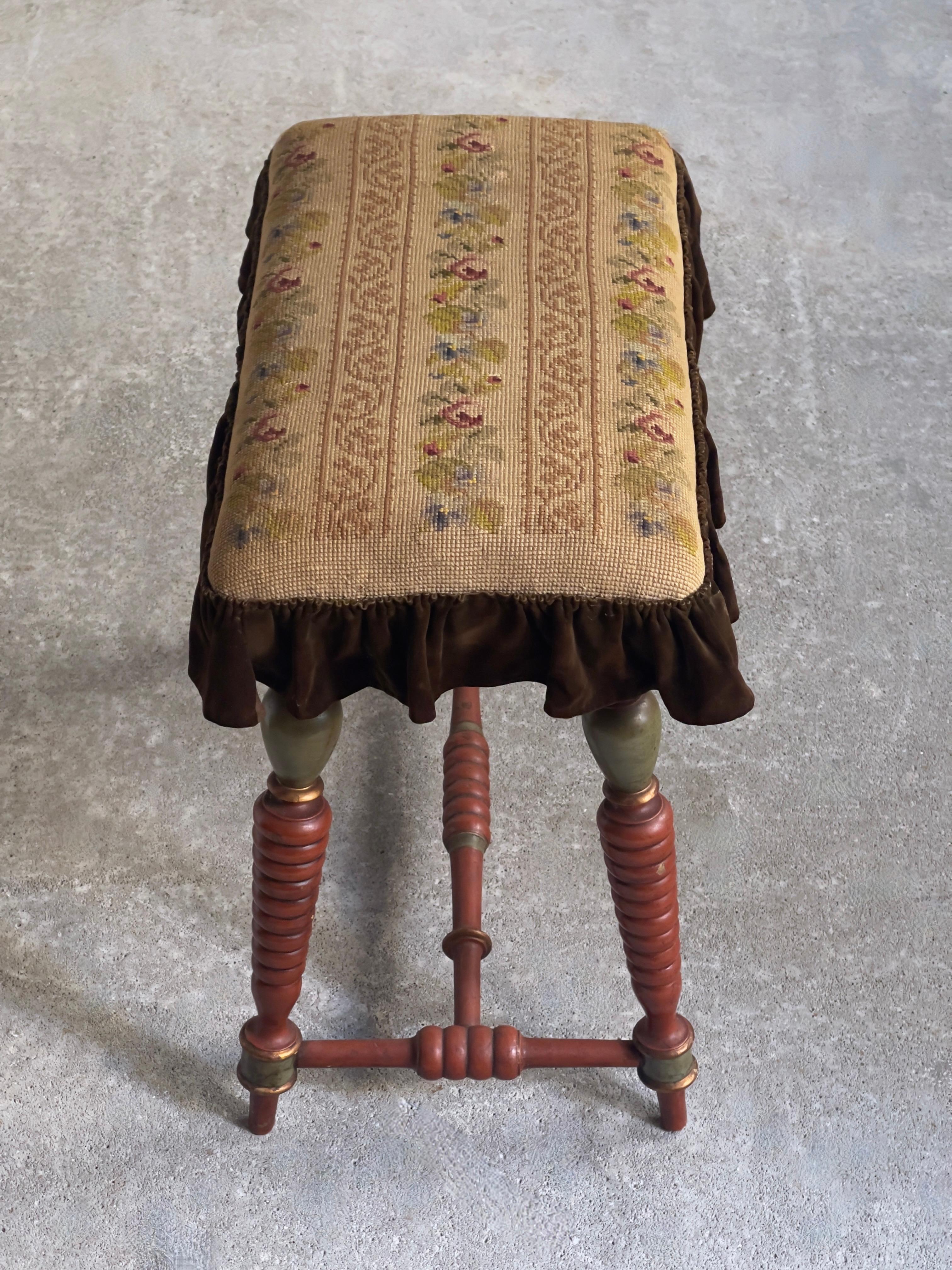 Wood Danish Late 19th century Stool with carved painted legs and embroidered seat. For Sale