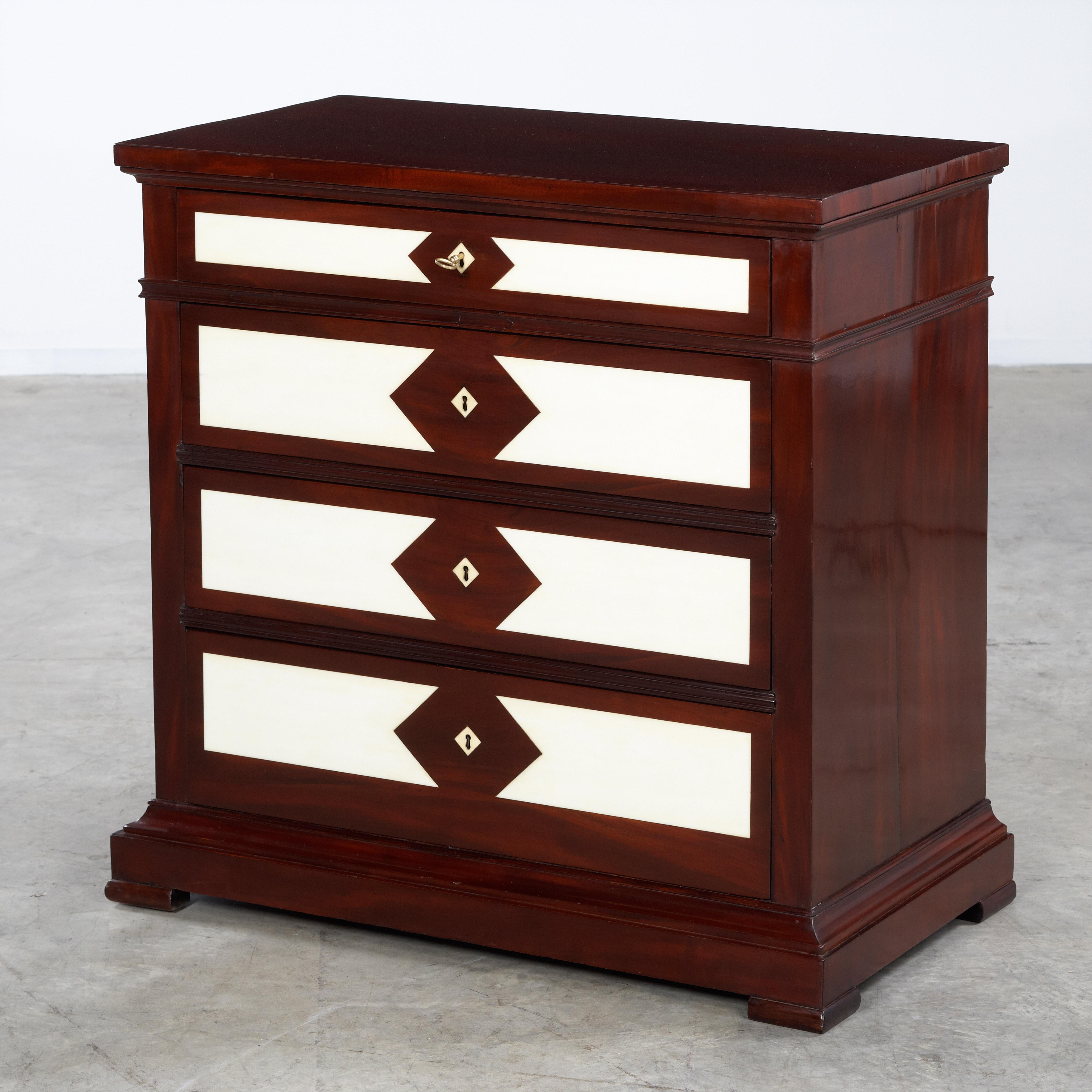 Very special late Empire chest of drawers with opaline glass inlay, 19th century, Denmark, 1830.  Mahogany with Ivory colored glass inlay.  Having four drawers with working locks, 1 key.   Beautifully proportioned chest of drawers with brilliant