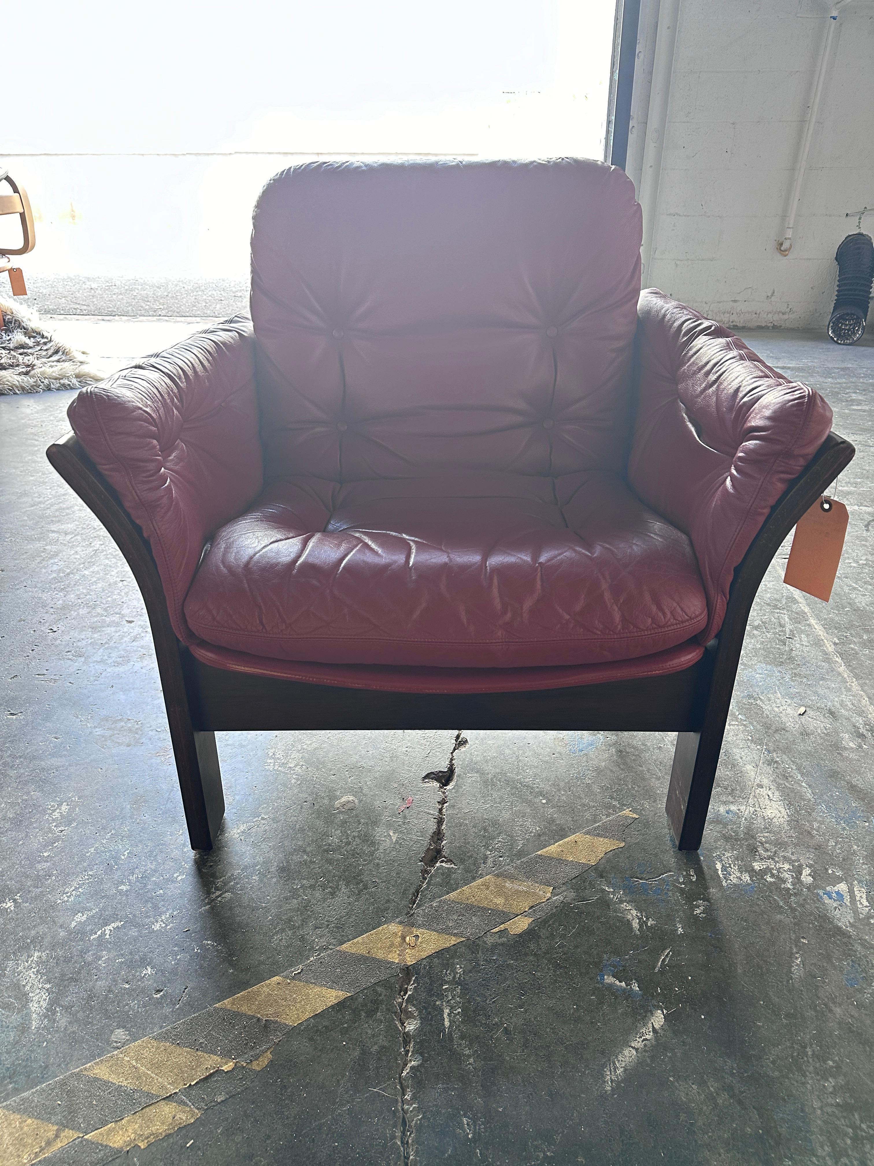 Deep red leather and suede chair by Thams Kvalitet. Features a wooden frame. In excellent condition with minimal age-consistent wear. Labeled.