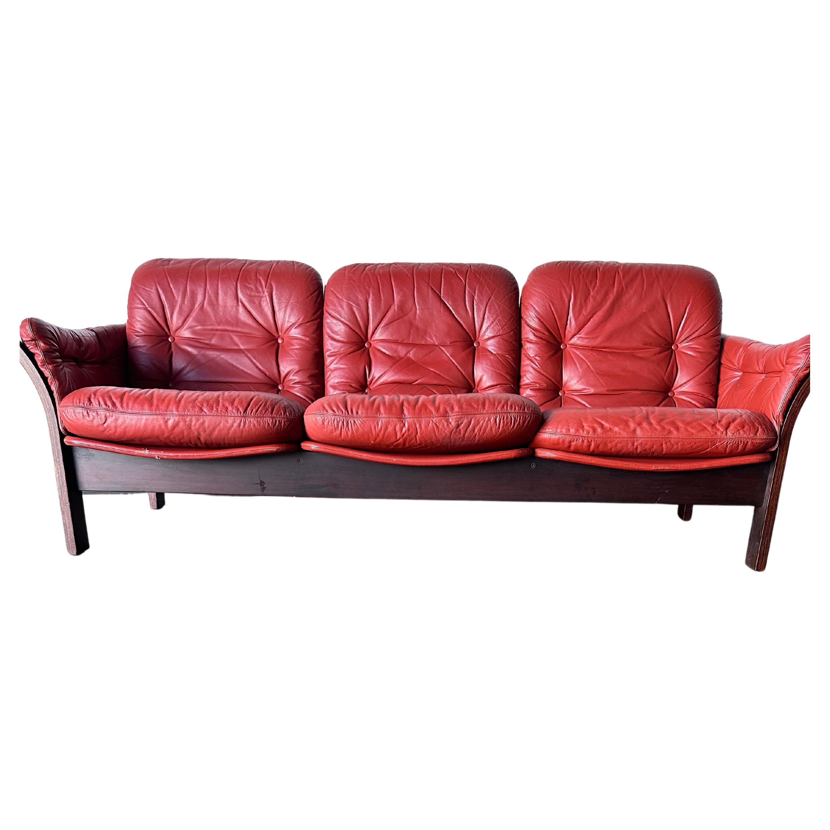 Deep red leather and suede Thams Kvalitet sofa with wood frame in excellent vintage condition. Three individual cushions. Labeled. Minor wear consistent with age.