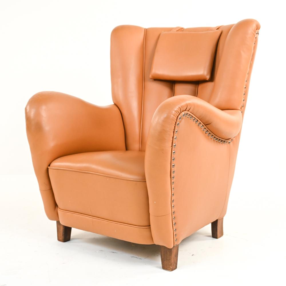 A handsome Danish Art Deco easy chair the manner of Viggo Boesen and Mogens Lassen's iconic designs. Fritz Hansen model 1672 style. Featuring warm orange-toned leather upholstery with attractive nailhead trim detail, this lounge chair epitomizes the