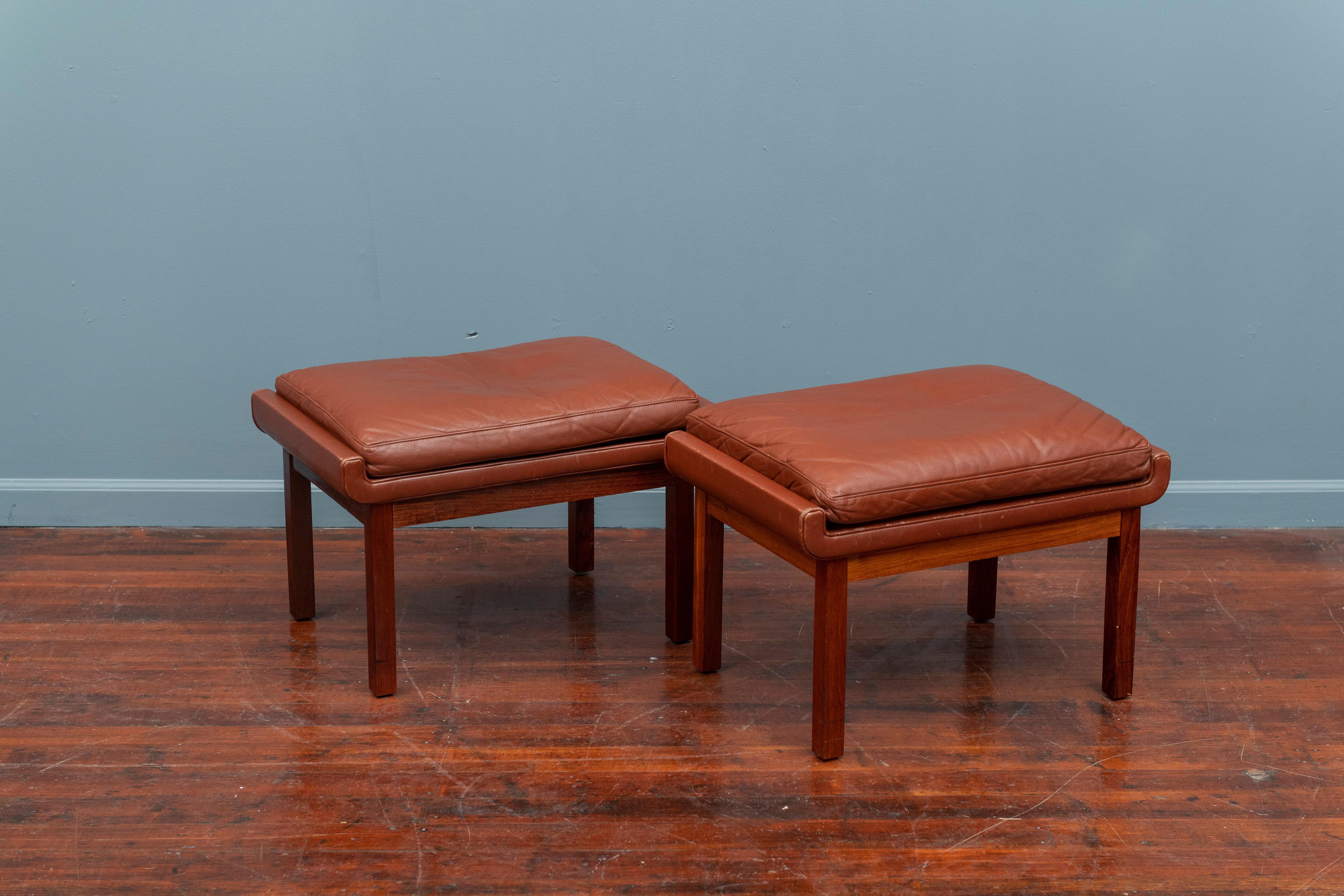 Pair of Danish rosewood and cognac leather ottoman.