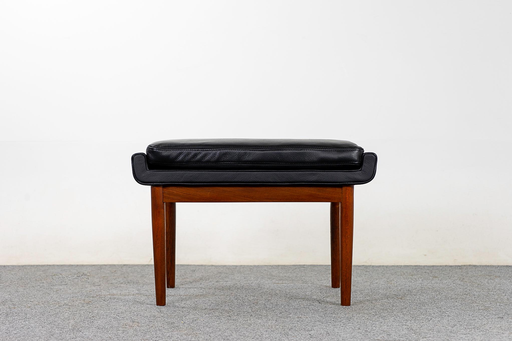 Leather and teak footstool, circa 1960s. Compact design can be used with virtually any seating type. Gorgeous leather with a soft pebble pattern. Sumptuous, pristine!

Please inquire for international shipping rates.
