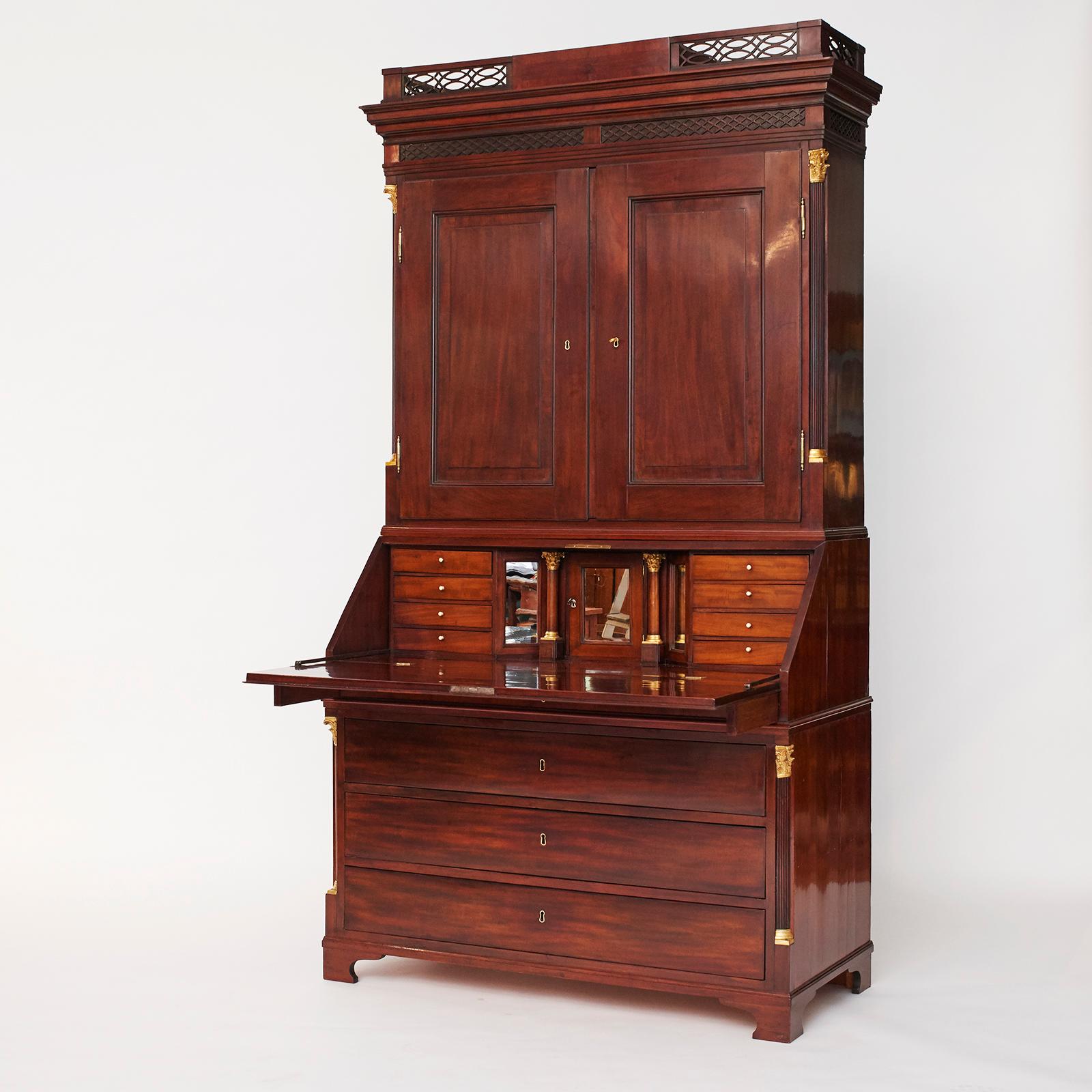 Danish Louis XVI bureau, mahogany. High-quality craftsmanship. Original condition, carefully restored. Top cabinet with detailing wood carvings. Top and bottom cabinet flanked by quarter-columns with gilded bronze capitals. Writing flap enclosing