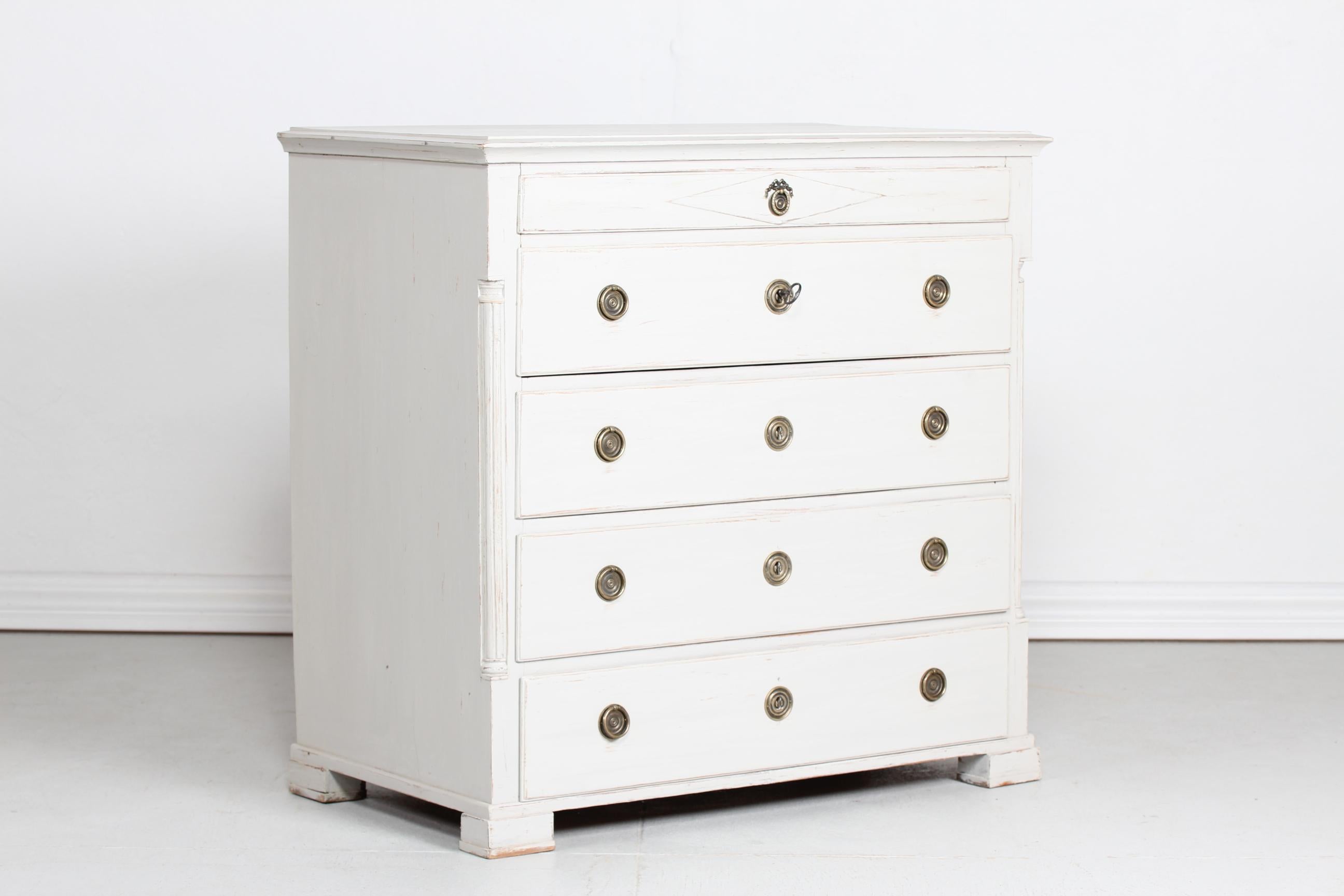 Danish Louis XVI Seize style chest of drawers made circa 1880 of solid pine wood. 
It has been hand painted with light grey paint and patina and later brass handles

Nice antique condition with good patina.
The key, drawers and locks are with
