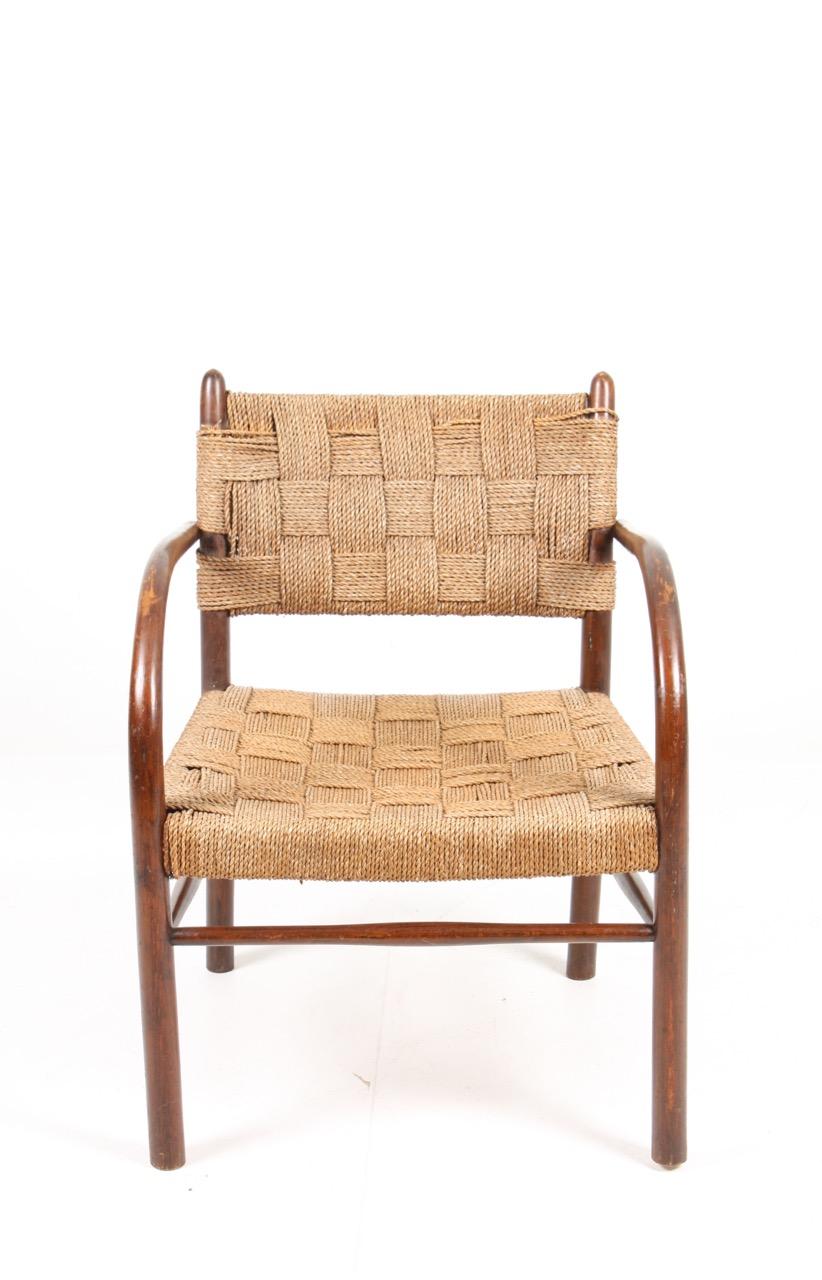 Lounge chair in beech and seagrass designed by Maa. Frits Schlegel, made by Danish cabinetmaker Fritz Hansen in the 1940s.