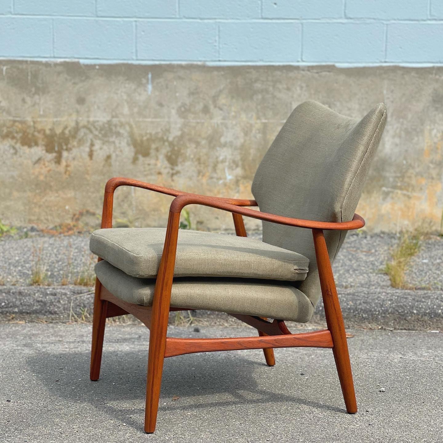 Early 1950s or late 1940s Ib Madsen & Acton Schubell designed lounge chair. I love the sculptural frame with ribbon-like narrow arms that I lightly hand sanded to keep some patina on the teak and show the age. The teak legs have amazing grain lines.