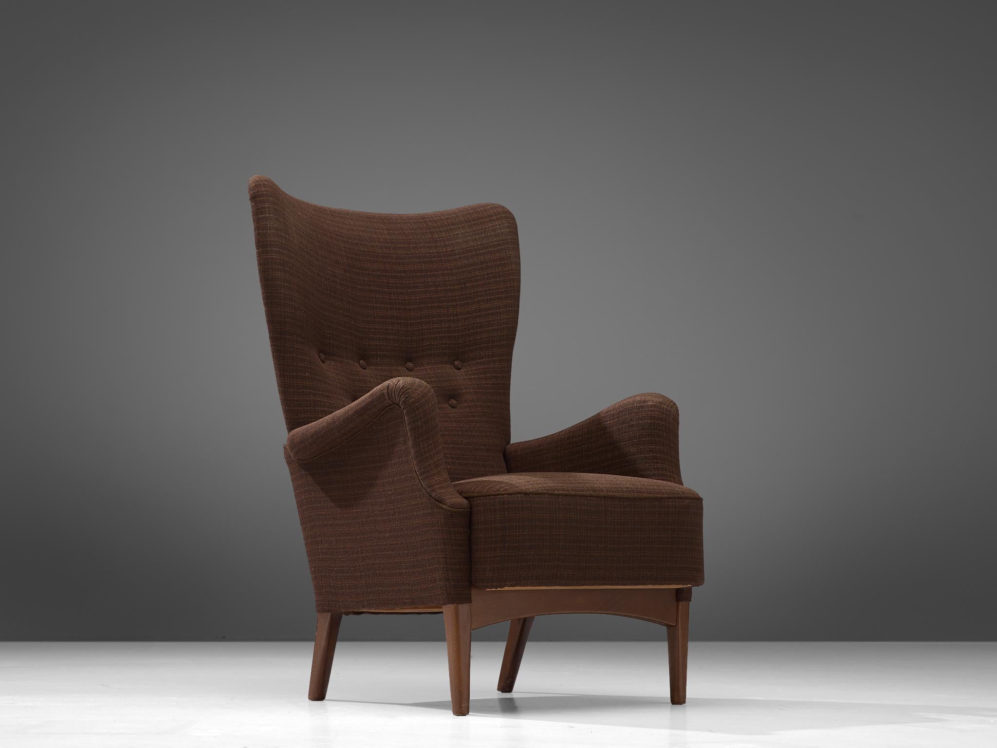 Armchair, brown fabric and beech, Denmark, 1950s

This stately and well-executed wingback chair shows an exquisite level of craftsmanship. The lines and finishes in this chair from 1950 are curvy yet crisp. The beech frame forms a solid and stabile